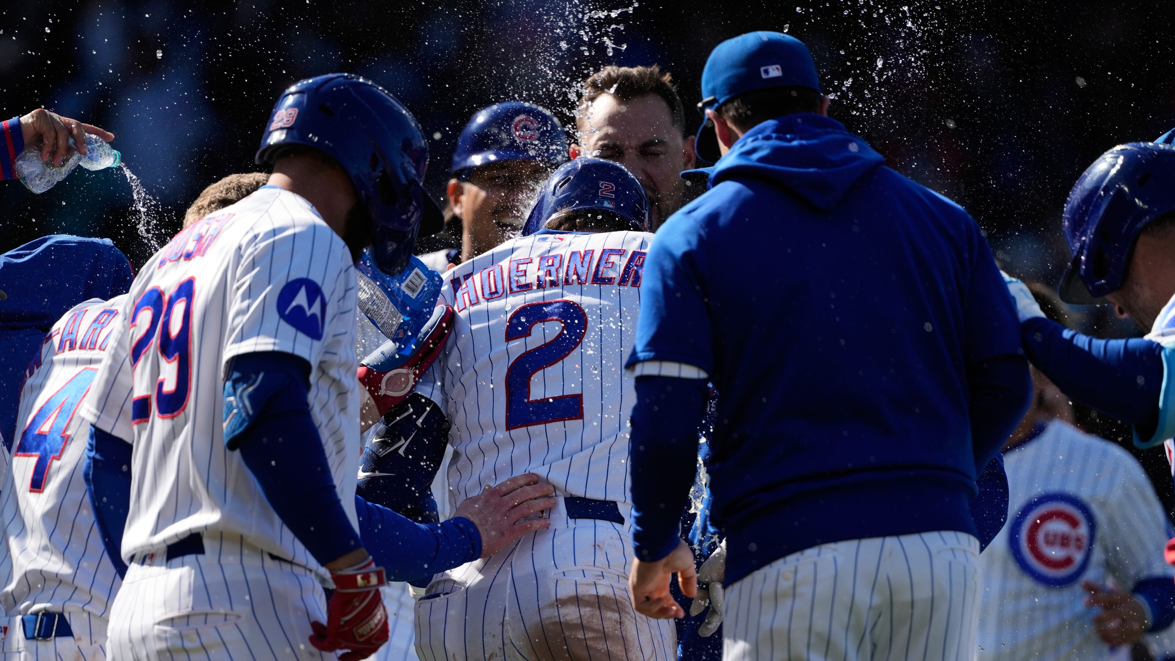 Chicago Cubs' Nico Hoerner (2) celebrates with teammates after hitting a sacrifice fly to New York Mets right fielder Tyrone Taylor during the 10th inning of a baseball game in Chicago, Sunday, April 19, 2026. (AP Photo/Nam Y. Huh)