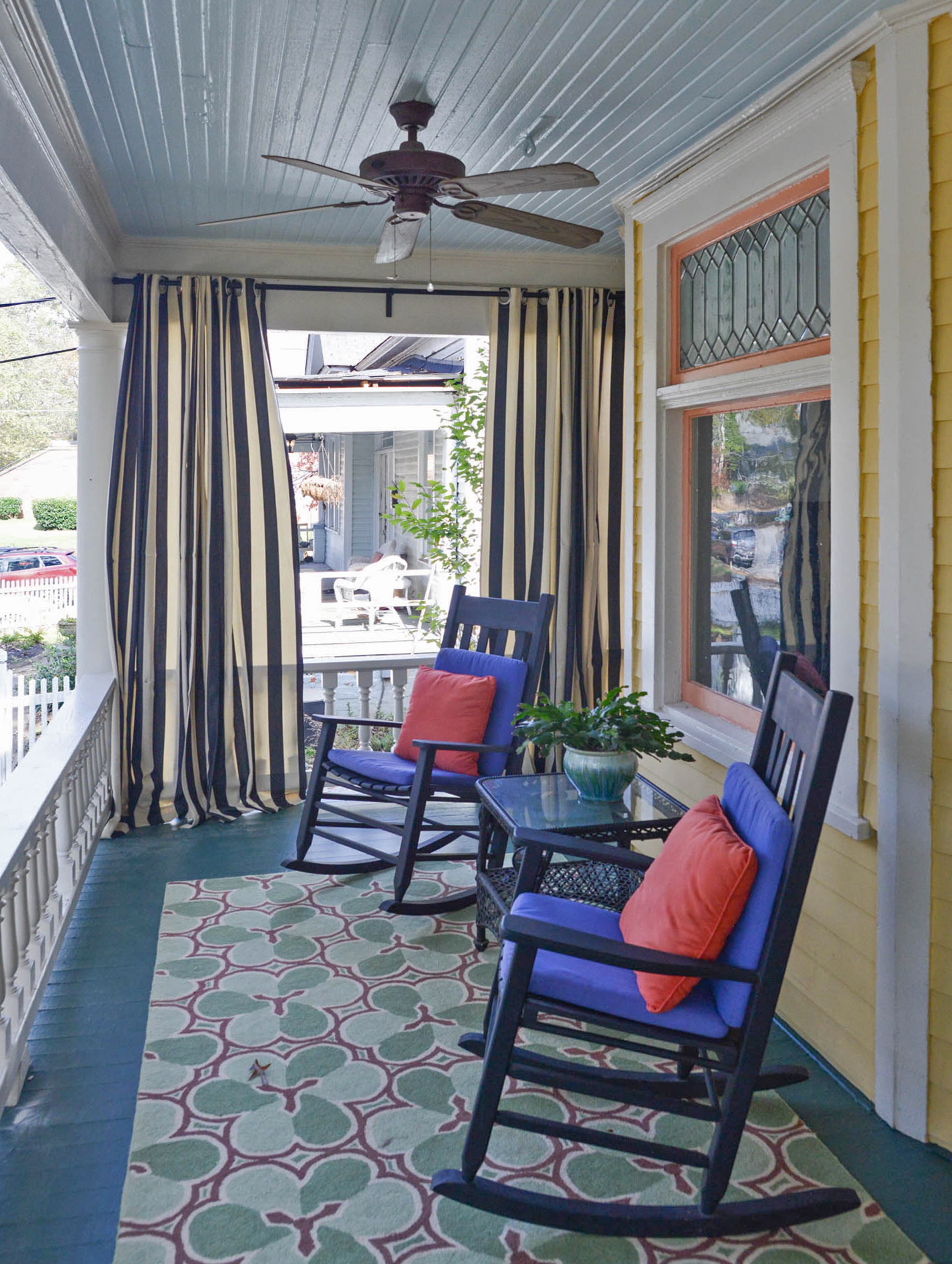 Kouters and Simpson did very little renovation when they purchased their home in 2017. On the front porch, they removed the screens and added curtains and seating. Today, they enjoy unobstructed views of Grant Park.