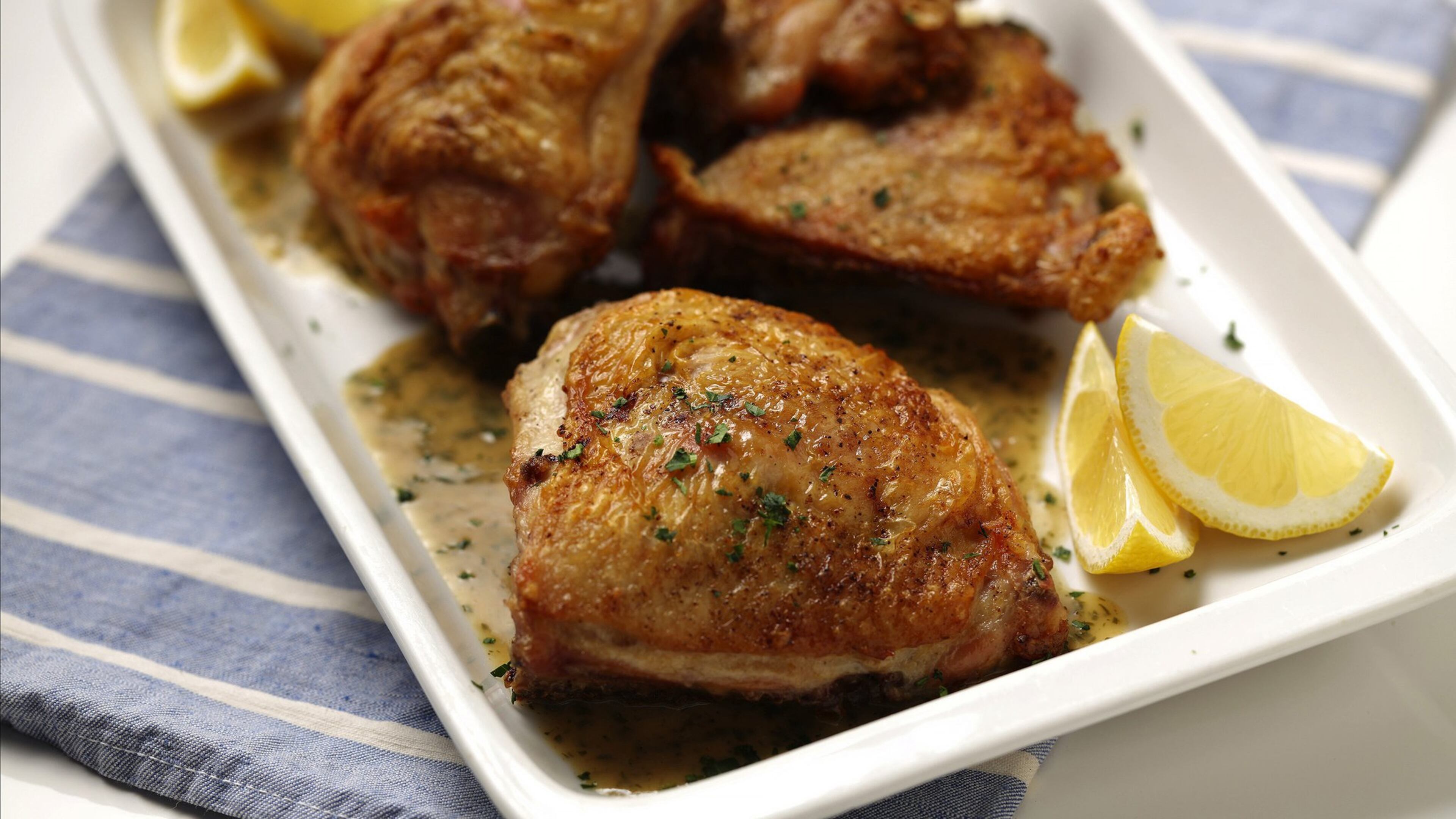 Chicken thighs start out on the stovetop, then are transferred right in the skillet to a hot oven. A quick pan sauce finishes the dish. (Mark Graham/food styling) (E. Jason Wambsgans/Chicago Tribune/TNS)