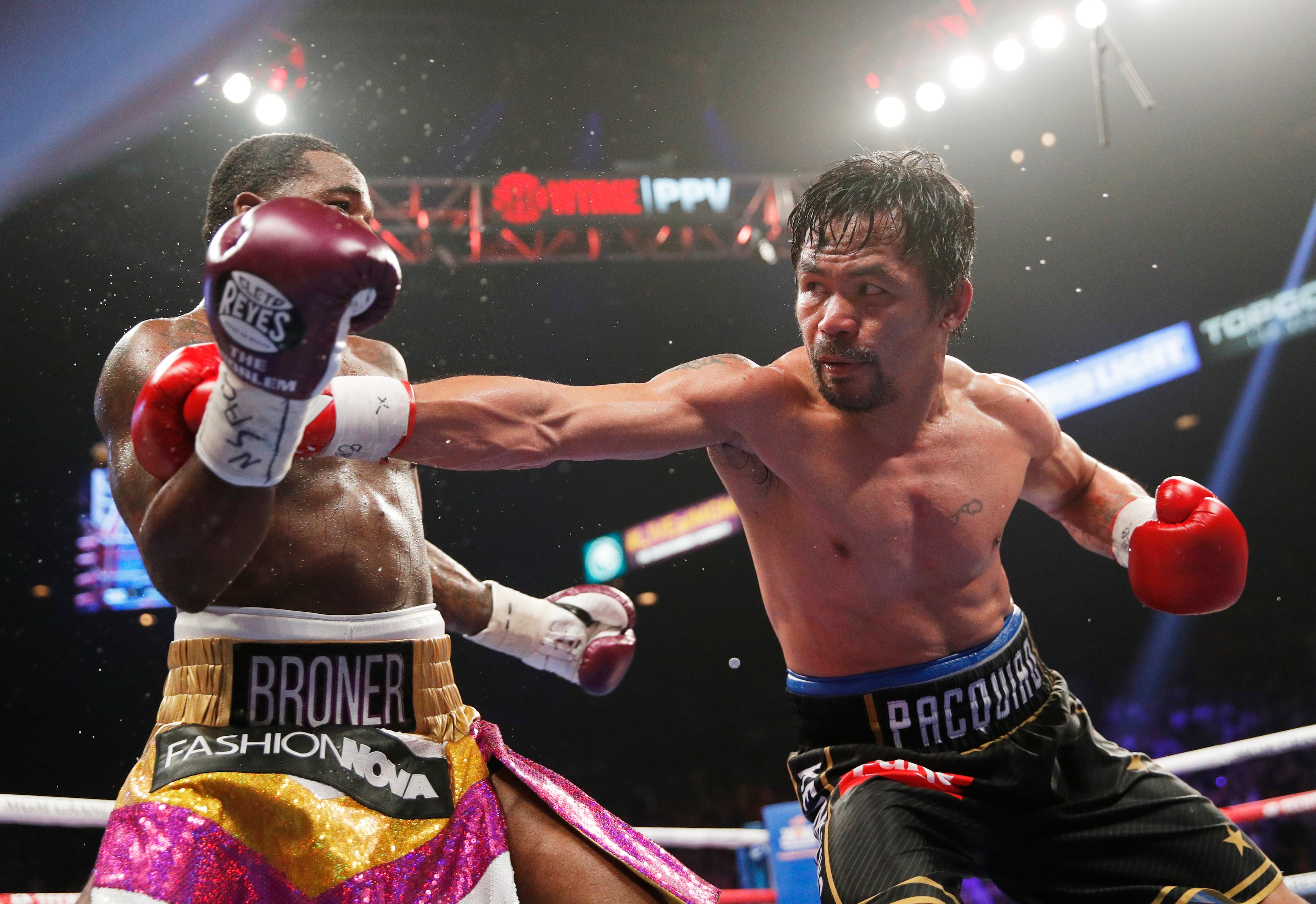 Manny Pacquiao, right, fights Adrien Broner in a welterweight championship bout Saturday, Jan. 19, 2019, in Las Vegas. (AP Photo/John Locher)