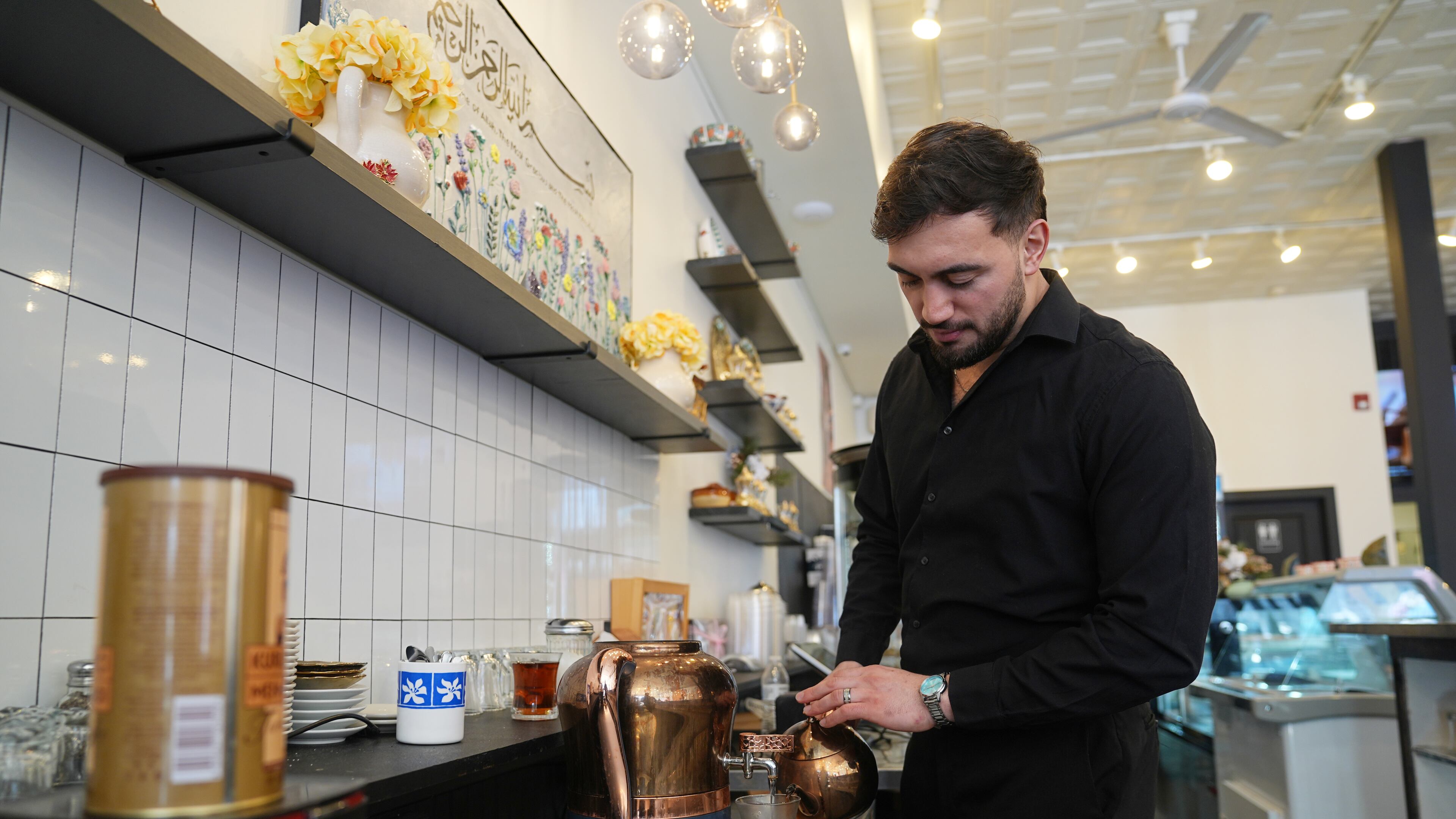 Muhammed Emanet pours Turkish tea for a guest at the Jersey Kebab restaurant, Thursday, Jan. 29, 2026, in Collingswood, N.J. (AP Photo/Matt Rourke)