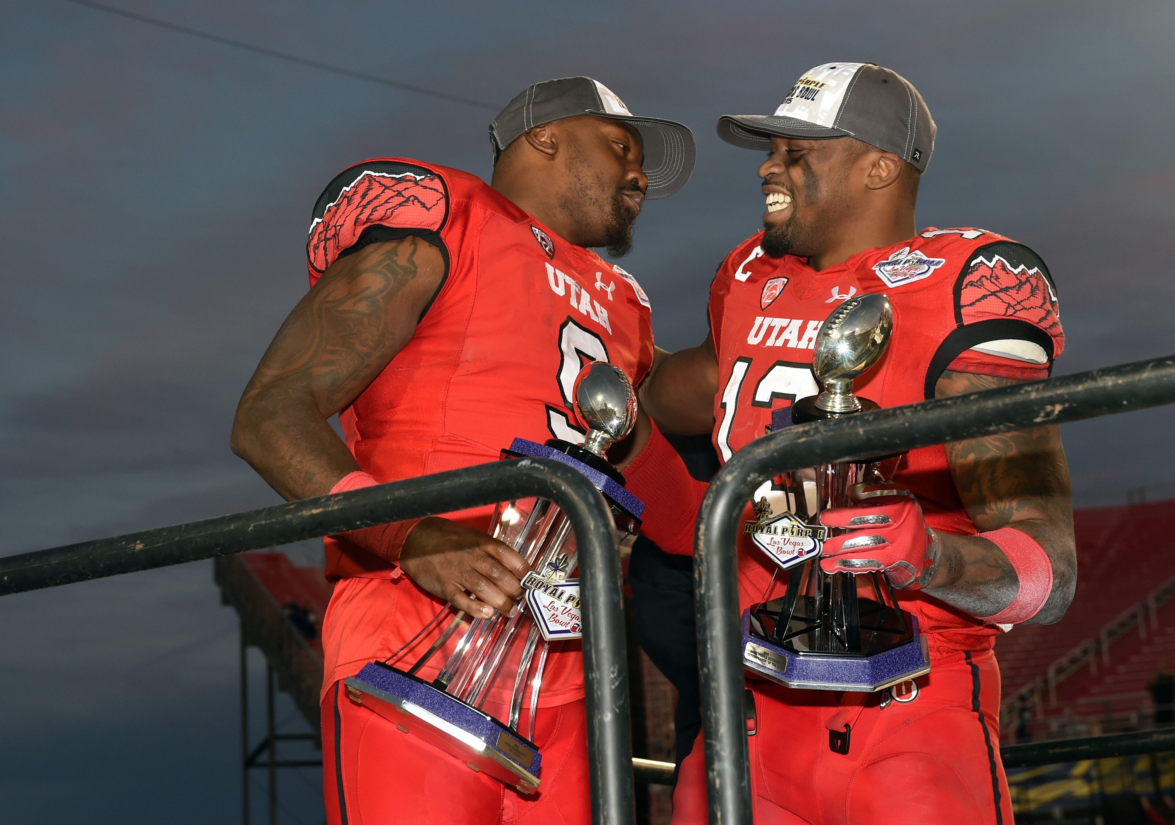 LAS VEGAS, NV - DECEMBER 19: Defensive back Tevin Carter #9 of the Utah Utes, winner of the most valuable player award, and linebacker Gionni Paul #13, winner of the defensive outperformer of the game award, celebrate after the Utes beat the Brigham Young Cougars 35-28 to win the Royal Purple Las Vegas Bowl at Sam Boyd Stadium on December 19, 2015 in Las Vegas, Nevada. (Photo by Ethan Miller/Getty Images)