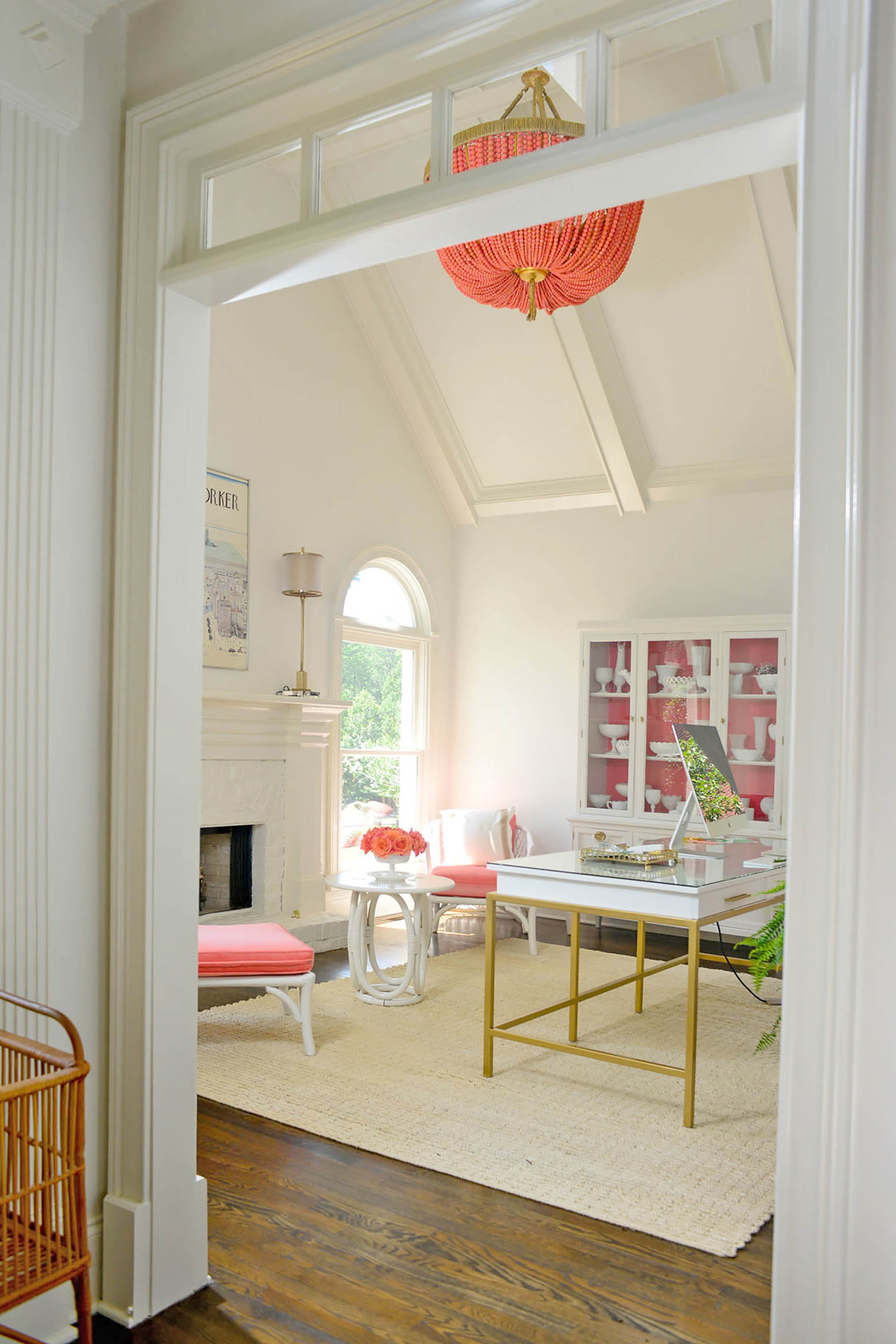 Edee said she loves adding pops of color against white walls, like this custom, beaded chandelier from AuCourant Interiors that's in her home office. The transoms allow this particular bright spot to be seen from other rooms.
