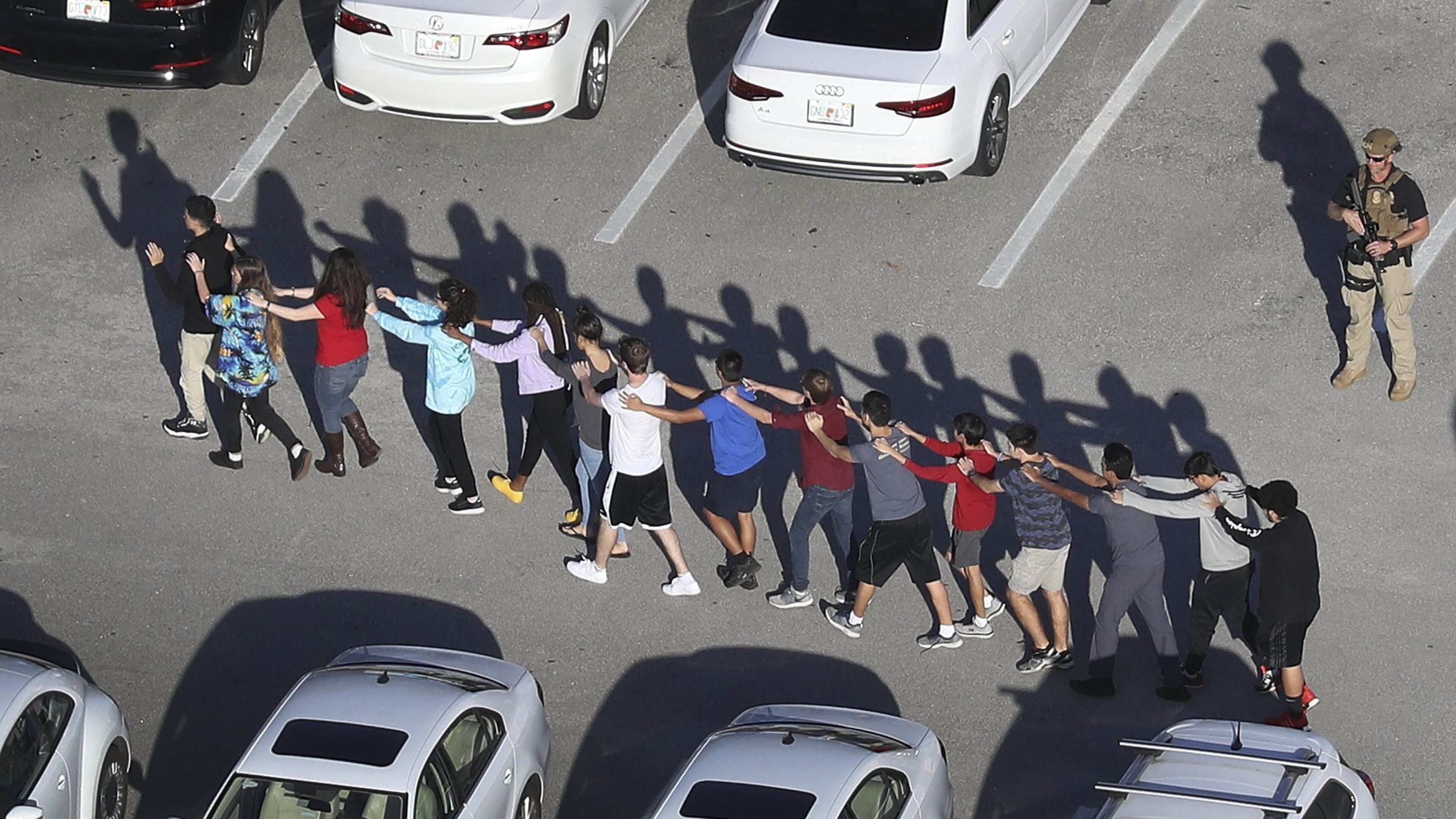 PARKLAND, FL - FEBRUARY 14: People are brought out of the Marjory Stoneman Douglas High School after a shooting at the school that reportedly killed and injured multiple people on February 14, 2018 in Parkland, Florida. Numerous law enforcement officials continue to investigate the scene. (Photo by Joe Raedle/Getty Images) *** BESTPIX ***
