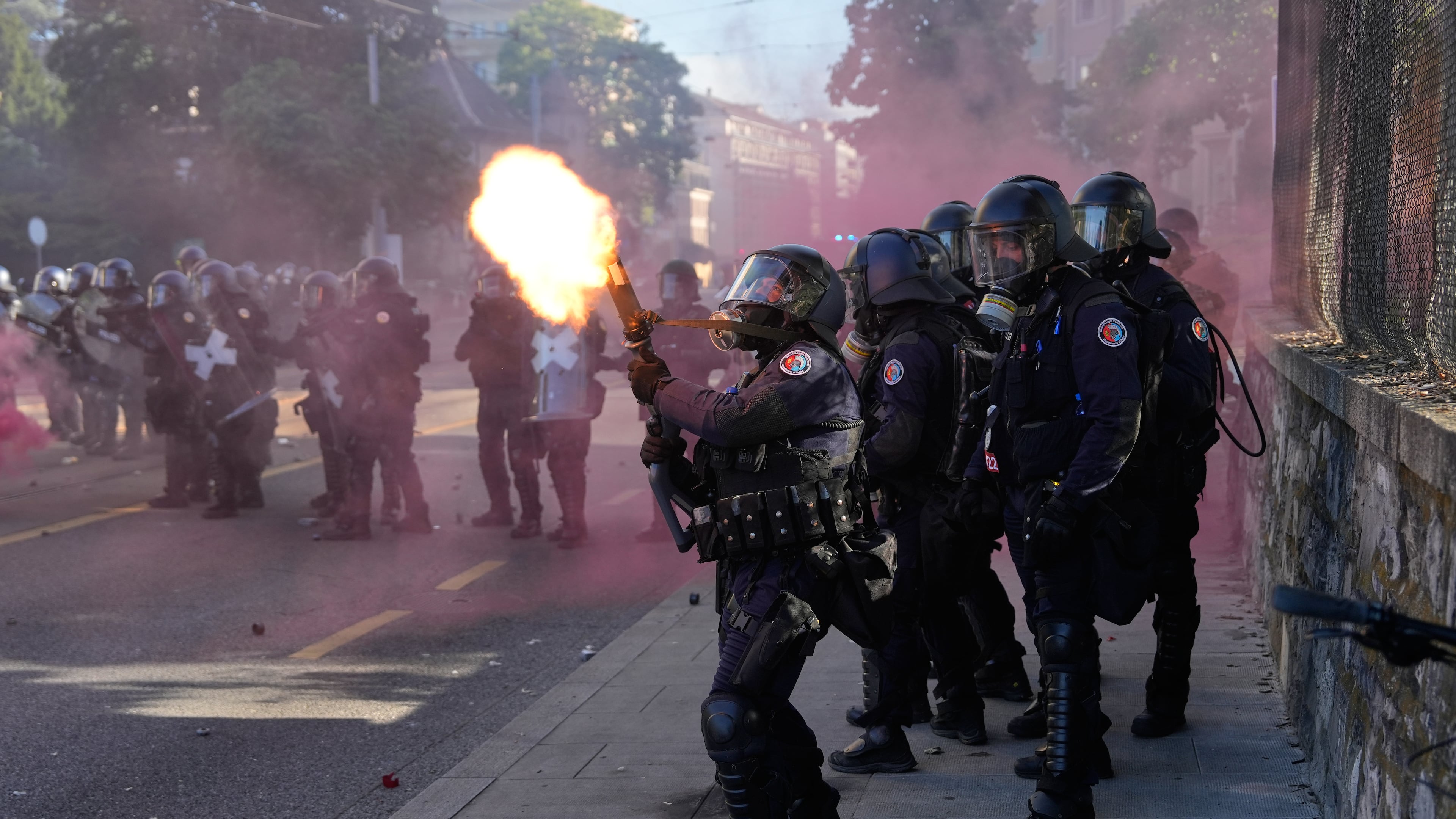 Police fire a tear gas canister during a "No G7" demonstration in Geneva, Switzerland, Sunday, June 14, 2026, ahead of the G7 summit scheduled to take place June 15-17. (AP Photo/Baz Ratner)