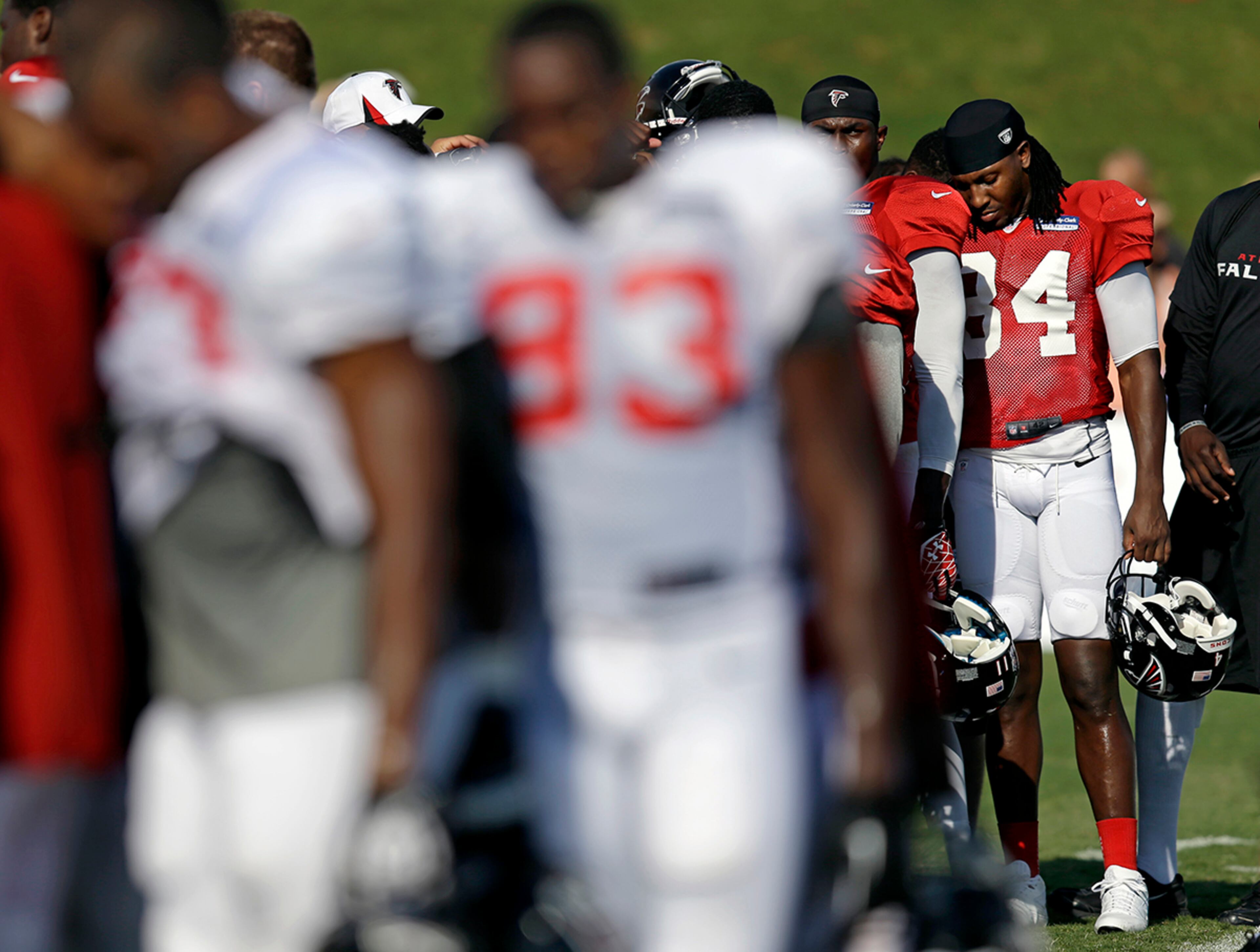 Falcons wide receiver Roddy White (84) huddles with teammates Monday during training camp at the team's practice facility in Flowery Branch. White will take a franchise-record streak of six straight seasons with more than 1,000 yards receiving into 2013. White says he knows expectations have changed for him and the Atlanta Falcons.