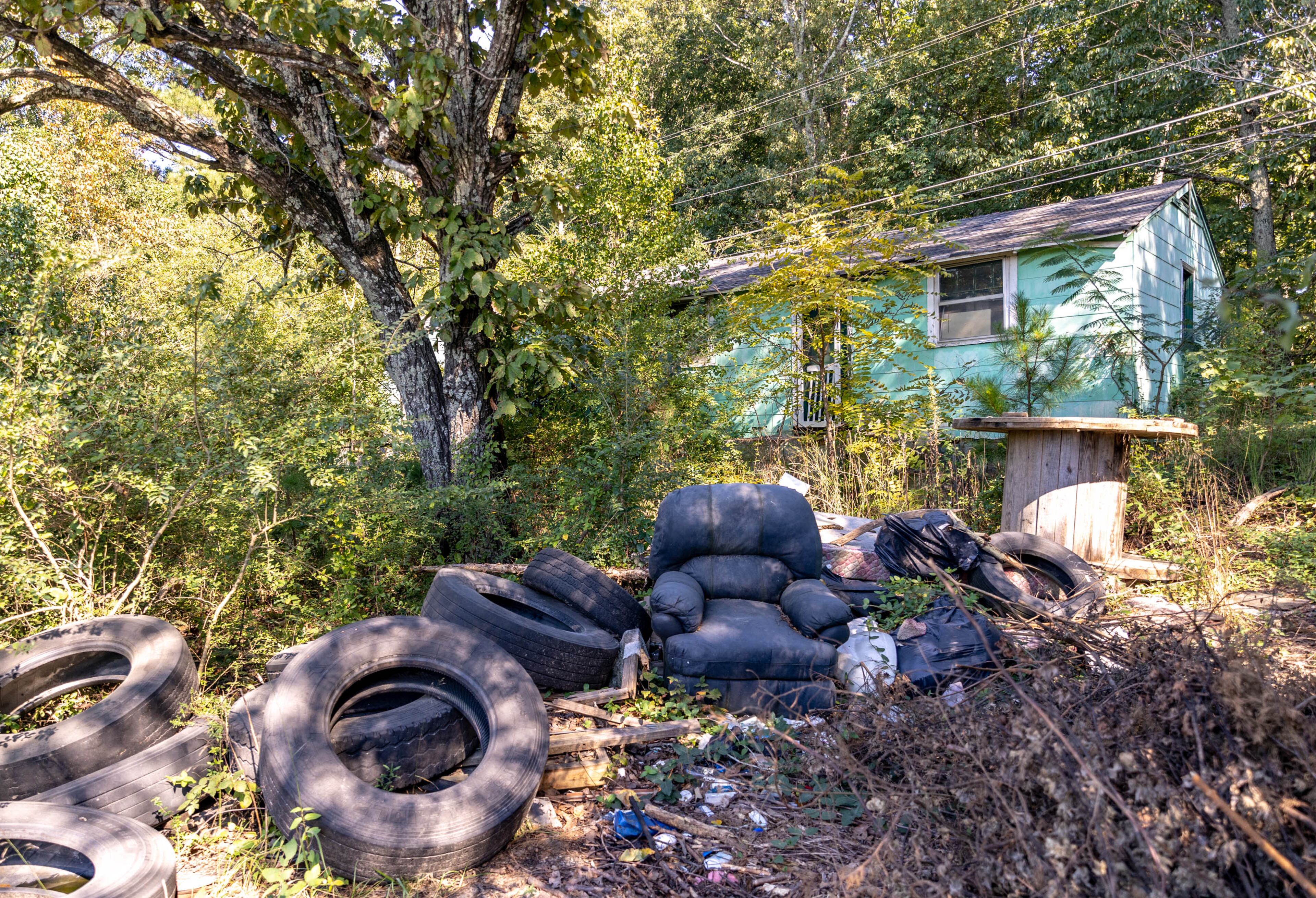 Stonecrest has several locations, including this abandoned home on Maddox Road near Rogers Lake Road, where illegal dumping and overflow parking is adjacent to abandoned, overgrown homes. Wednesday, Sept 29, 2021. (Jenni Girtman for The Atlanta Journal-Constitution)