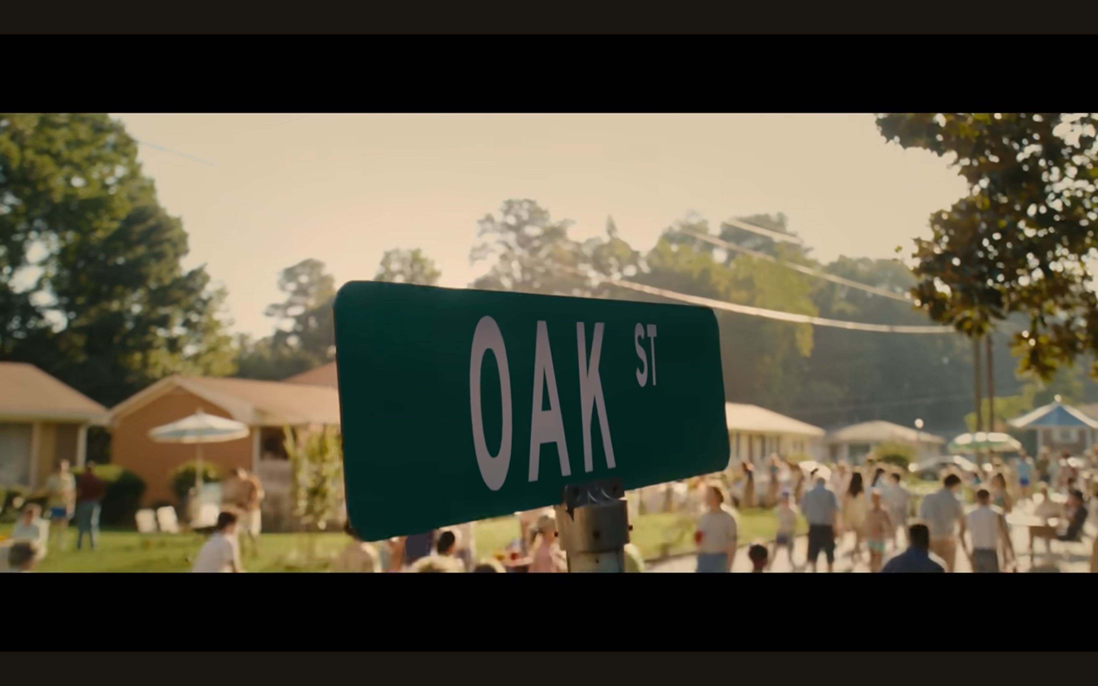 The beginning of "The End of Oak Street" features a block party in 1982 that was shot in 2024 in Wisteria Gardens on the corners of Dover Blvd. and Dover Ct. An "Oak St." sign replaced the "Dover Ct." sign. (Courtesy of Warner Brothers)