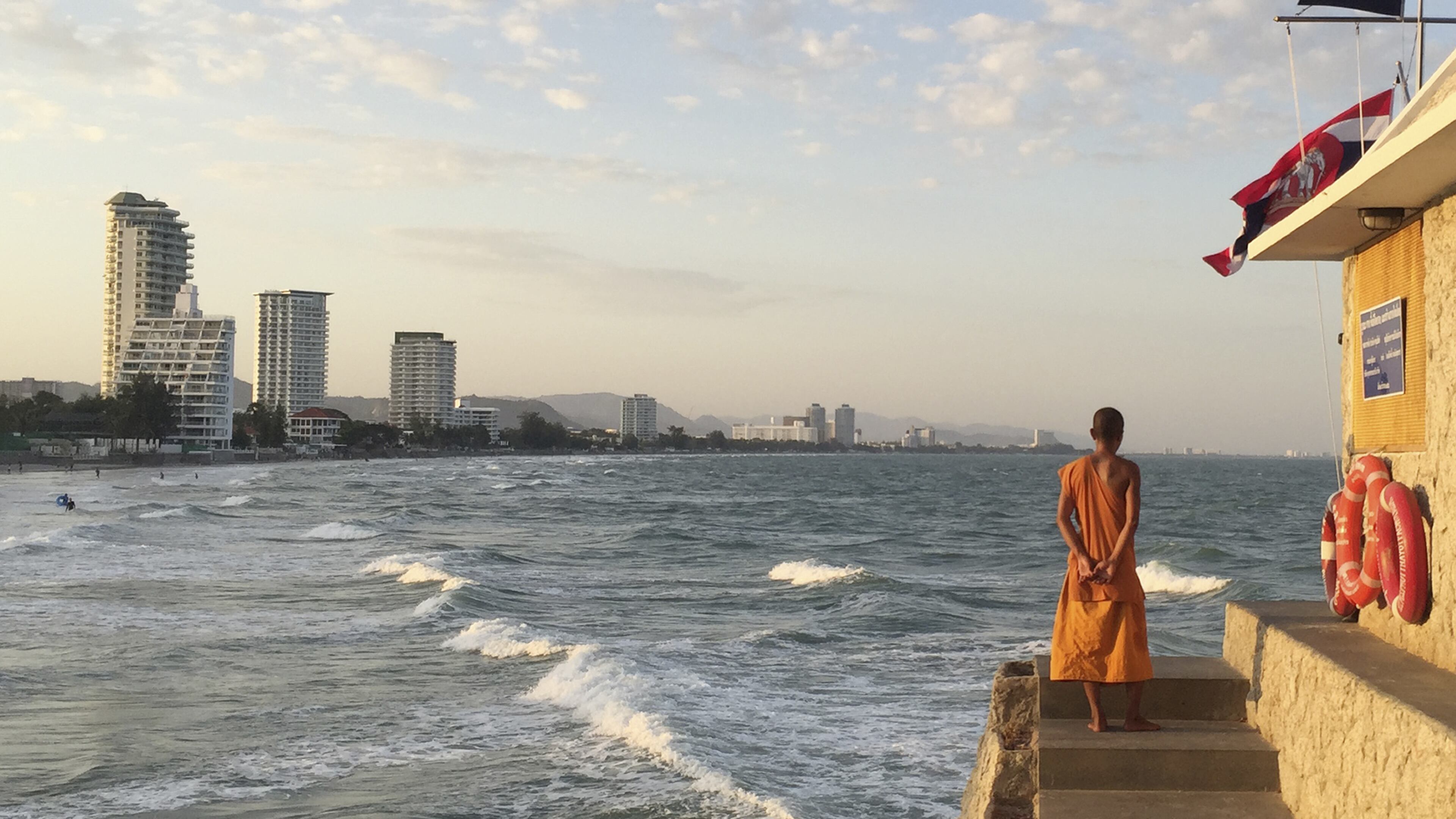 In this Dec. 31, 2015, photo, a Buddhist monk looks out on the beach in the resort town of Hua Hin, 240 kilometers (150 miles) south of Bangkok, Thailand. Police on Friday, Aug. 12, 2016, have confirmed that another person has died in a new bomb blast in the southern resort city of Hua Hin, hours after twin explosions killed one woman and wounded several others late Thursday. (AP Photo/Charles Dharapak)