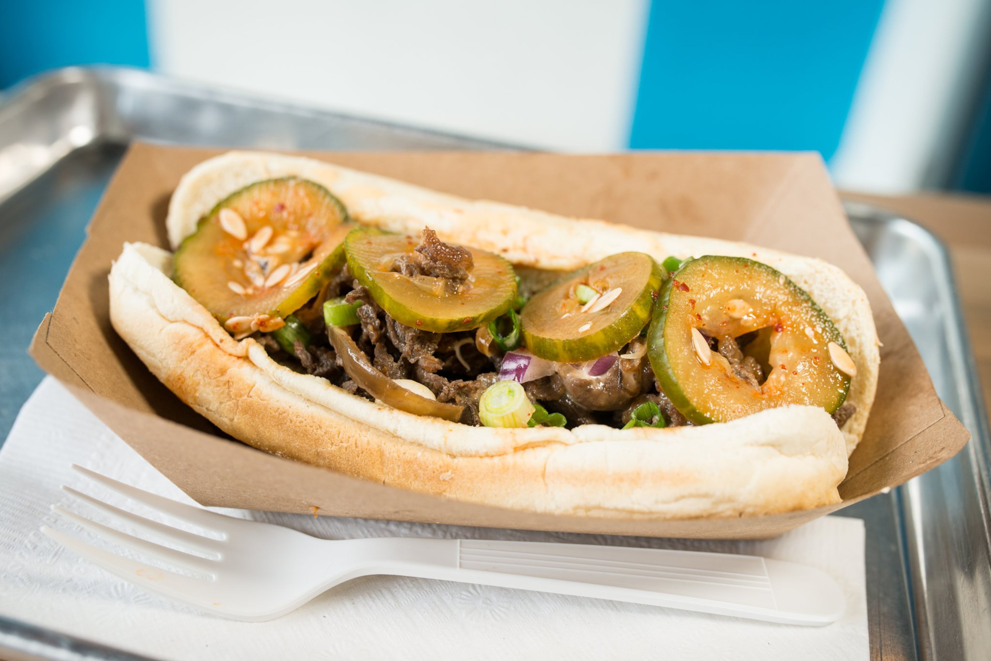 Yumbii Philly sandwich with beef, cucumber kimchi, onions, and Sriracha queso. Photo credit- Mia Yakel.