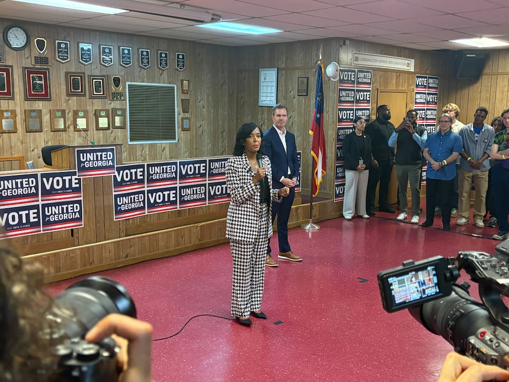 Democratic nominee for governor Keisha Lance Bottoms, left, speaks during a campaign event on Monday in Atlanta as Kentucky Gov. Andy Beshear, right, listens. (Riley Bunch/AJC)