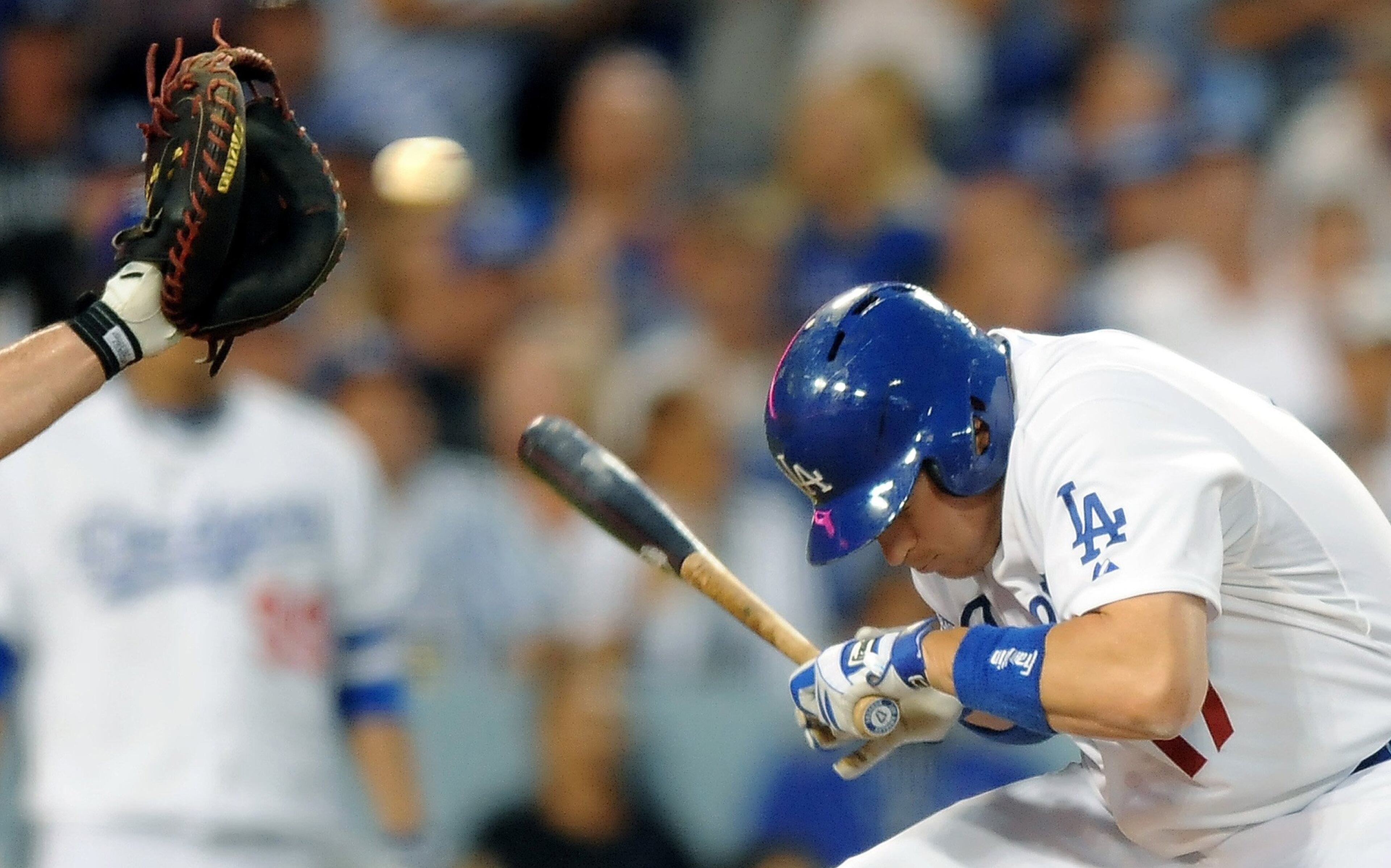 Los Angeles Dodgers A.J. Ellis avoids a high pitch from Atlanta Braves pitcher Julio Teheran in the 3rd inning during Game 3 of the National League Division Series at Dodger Stadium in Los Angeles, California, Sunday, Oct. 6, 2013.