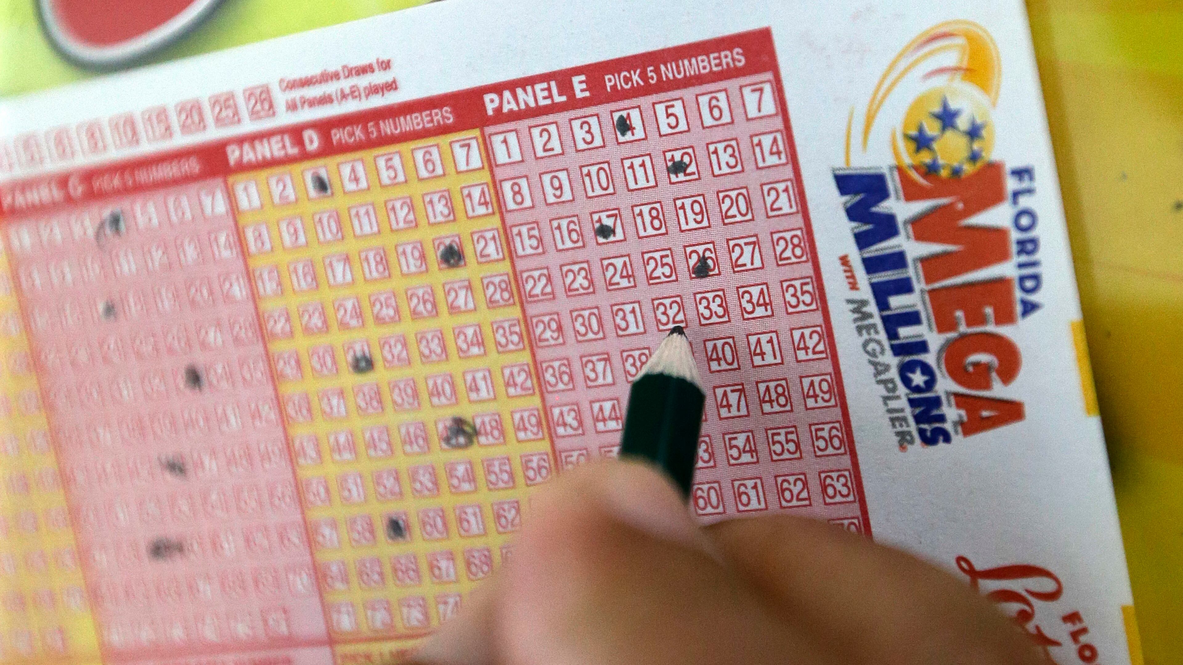 A customer fills out a Mega Millions ticket at a local grocery store, Friday, July 1, 2016, in Hialeah, Fla. Friday night's Mega Millions drawing will give lottery players a shot at the 10th largest jackpot in U.S. history. (AP Photo/Alan Diaz)