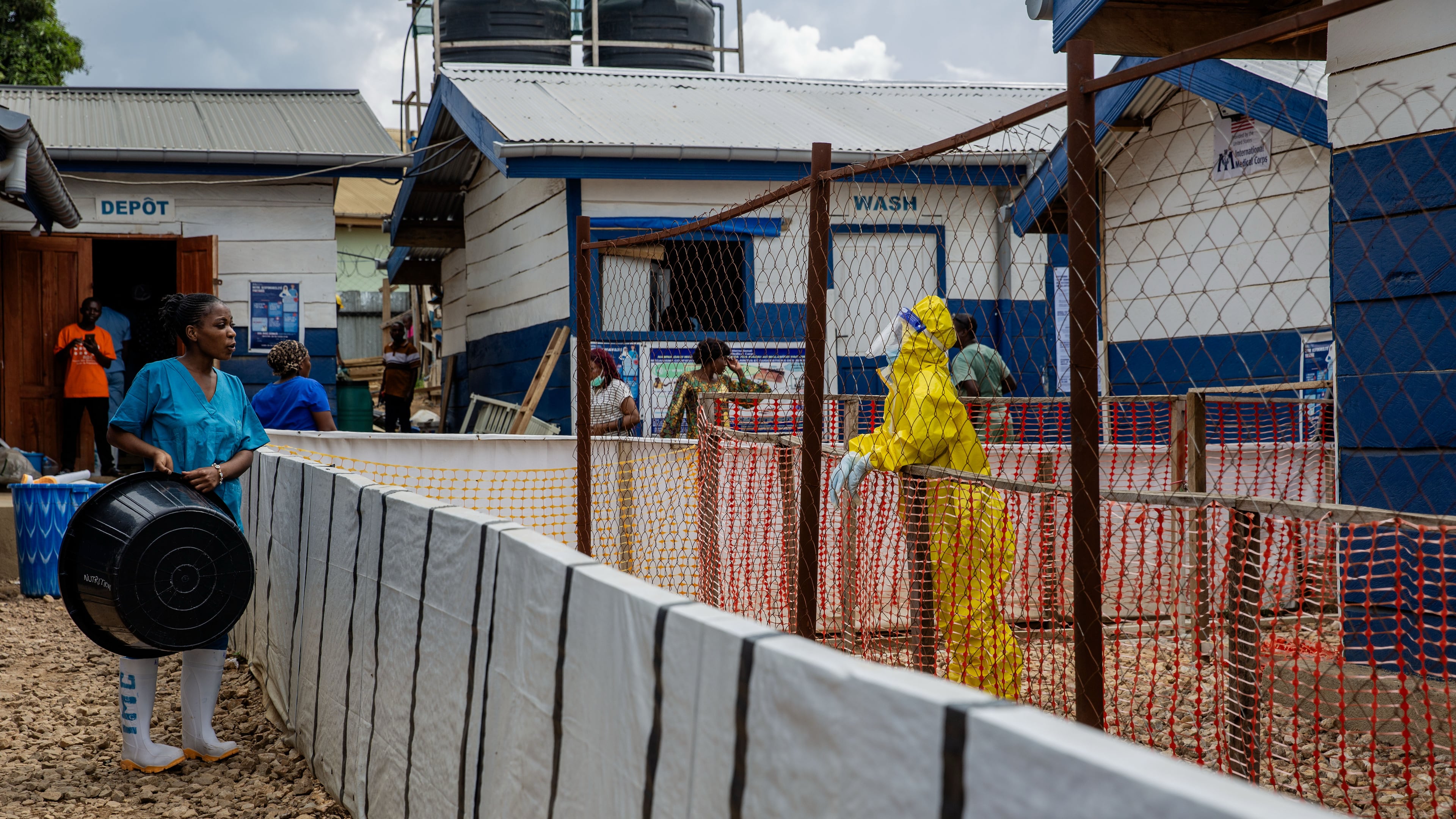 A healthcare worker speaks to a colleague at the Ebola treatment center in Beni, North Kivu province, Congo, Monday, Oct. 19, 2026. (AP Photo/Sebastien Kitsa Musayi)
