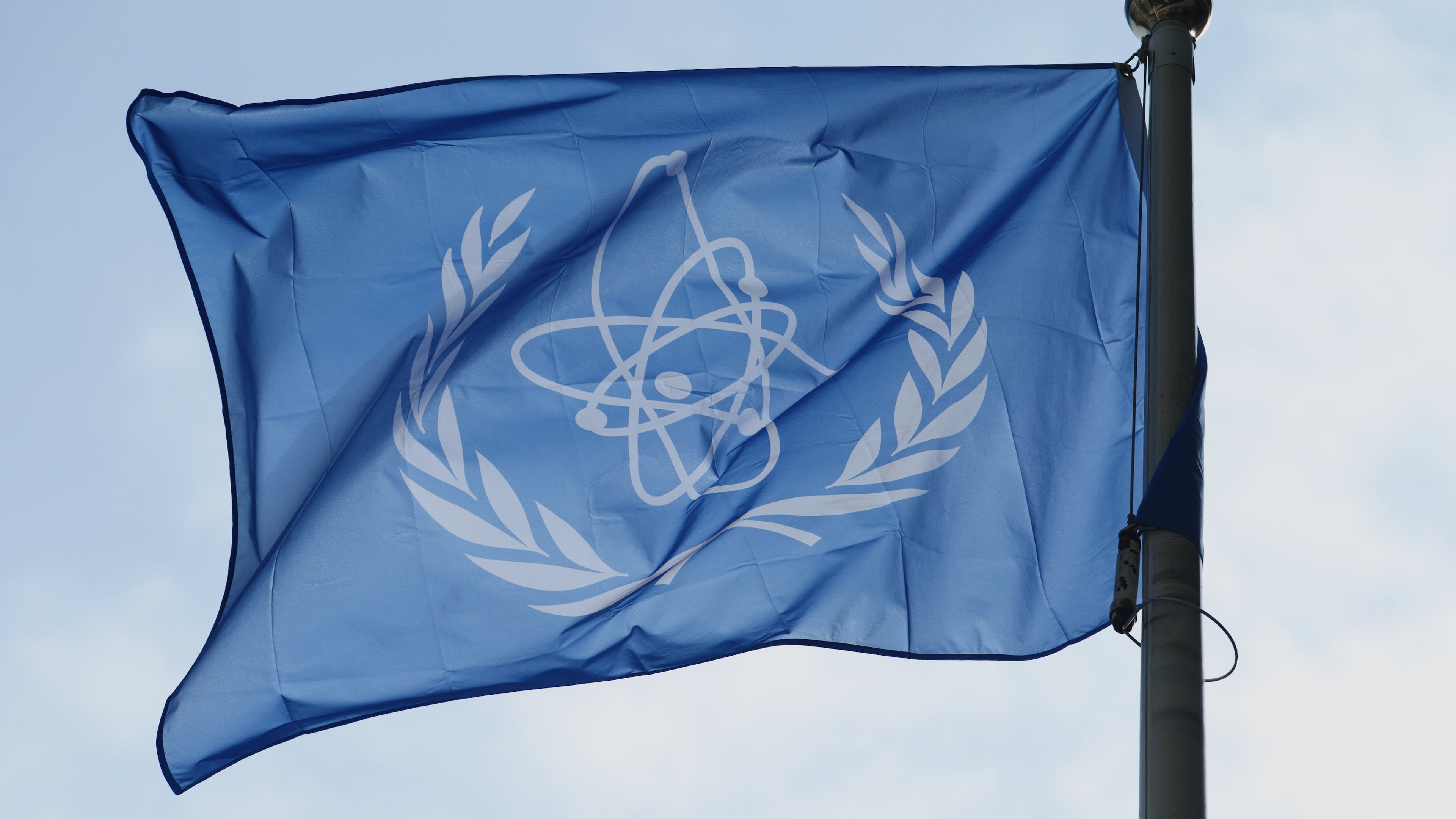 FILE - The flag of the International Atomic Energy Agency (IAEA) flies during a special session of an IAEA Board of Governors meeting in Vienna, Austria, March 2, 2026. (AP Photo/Heinz-Peter Bader, File)