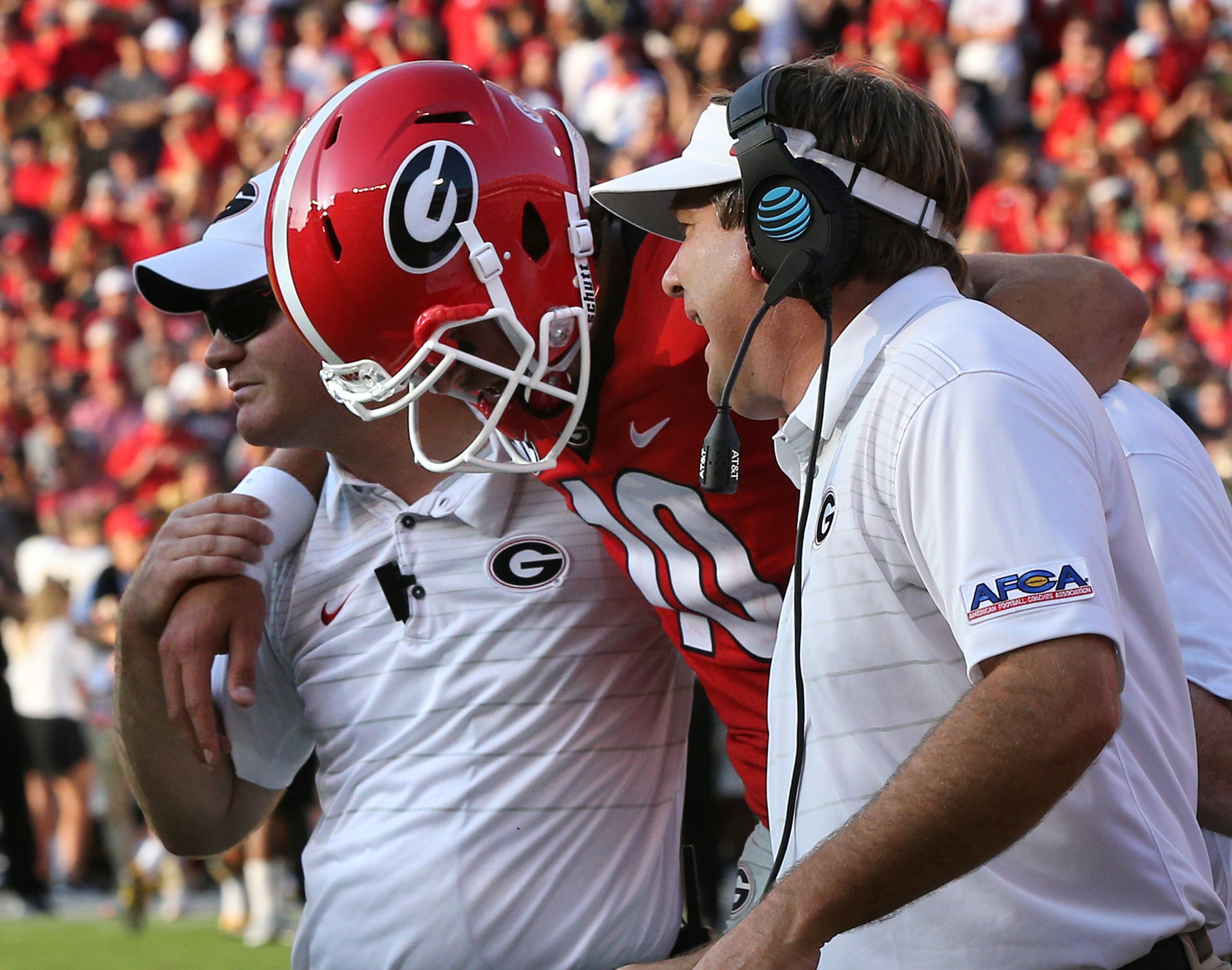 September 2, 2017 Athens: Georgia head coach Kirby Smart checks on quarterback Jacob Eason as he is helped off the field leaving the game with an injury during the first quarter against Appalachian State in a NCAA college football game on Saturday, September 2, 2017, in Athens. Curtis Compton/ccompton@ajc.com