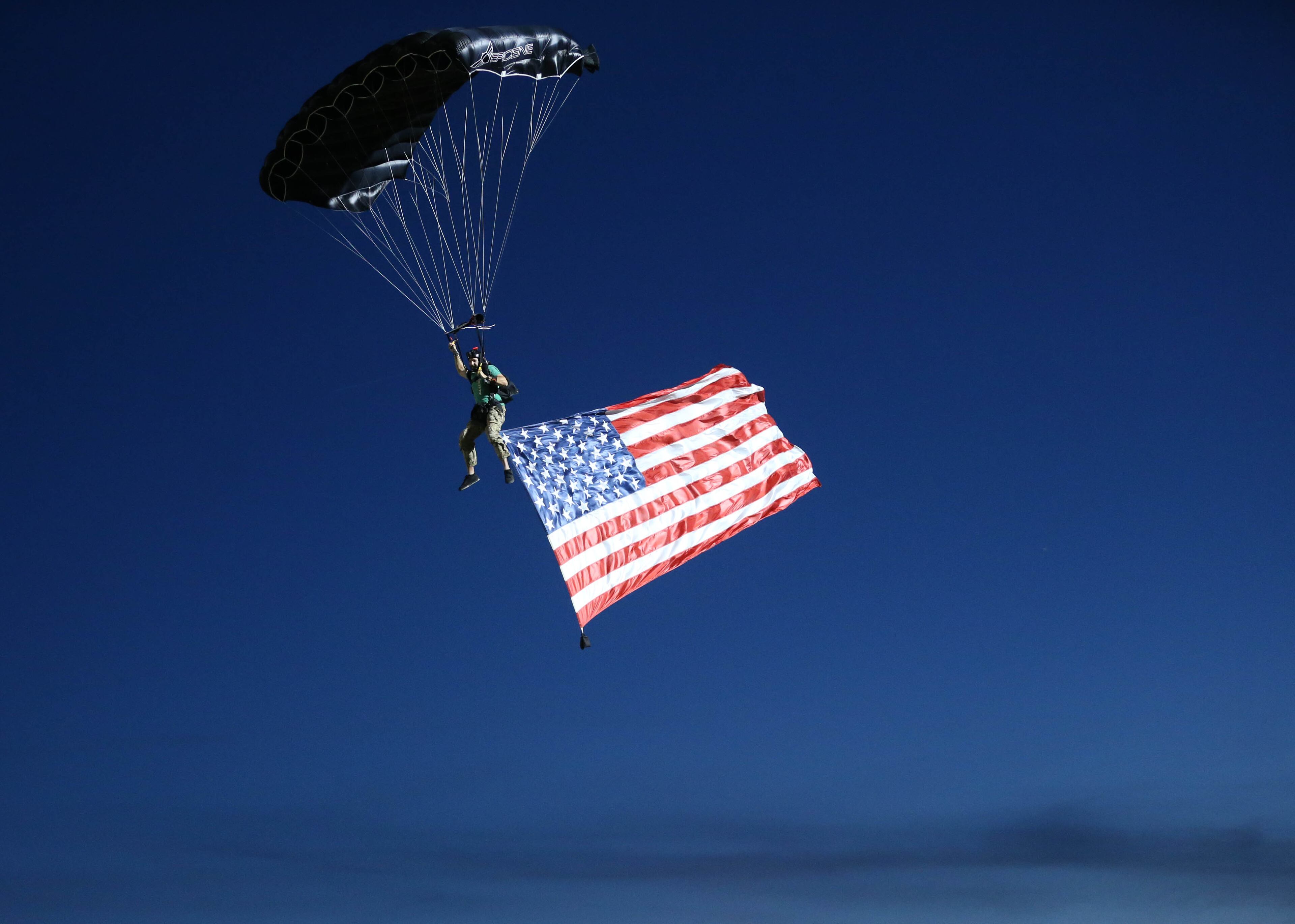 October 20, 2017 - Lilburn, Ga: A sky diver parachutes toward the field holding a U.S. flag before the game against Brookwood and Parkview at Parkview High School Friday, October 20, 2017, in Lilburn, Ga.. PHOTO / JASON GETZ