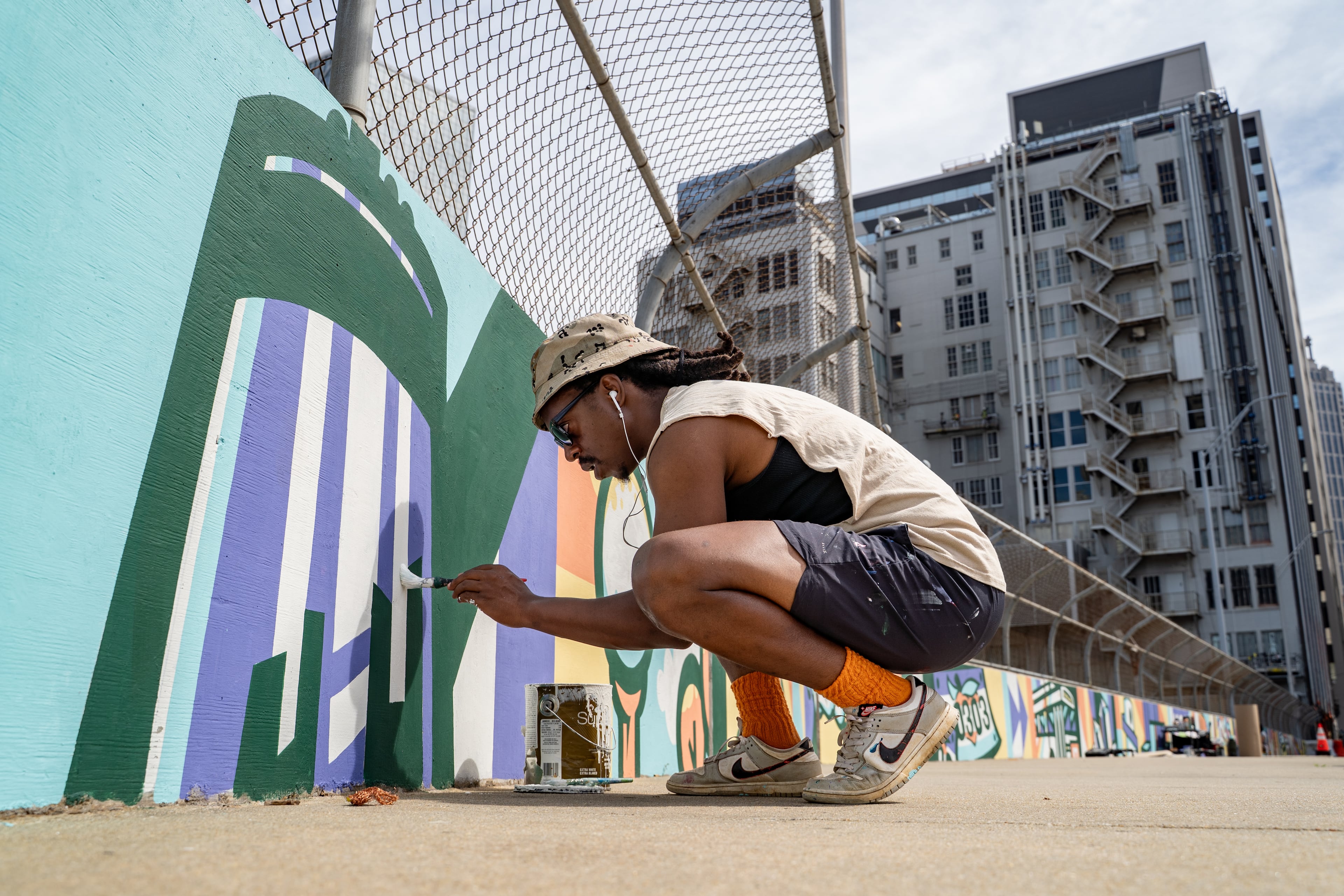 Muralist Jaleel Wimbush paints a mural on a wall along Forsyth Street on Friday, June 5, 2026. (Ben Hendren for the AJC)