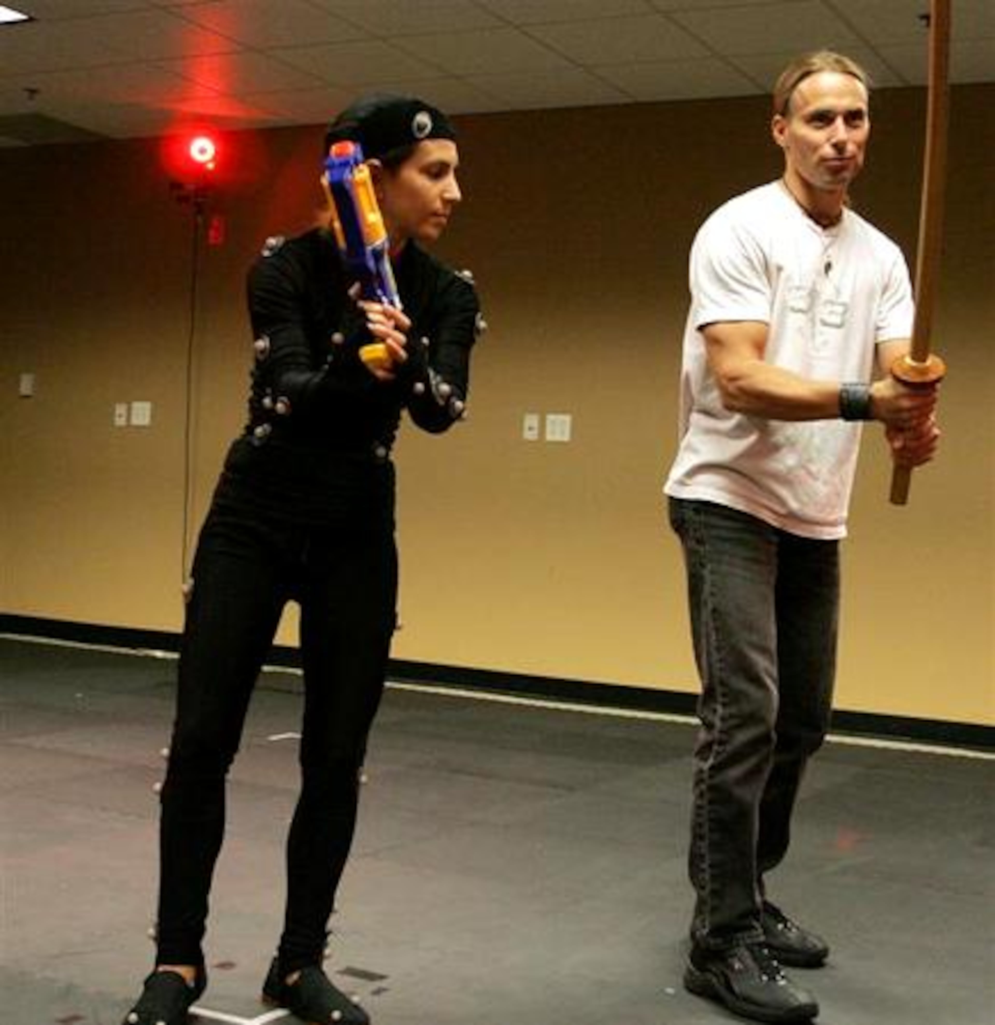 Daniel Lilleberg(right)works with Michal Adam during a motion capture session at Hi-Rez Studios in Alpharetta. Adam dressed in a costume with "markers" on it for video used in computer animation. Multiple cameras around the room capture the "markers" on Adam to create a three dimensional image.