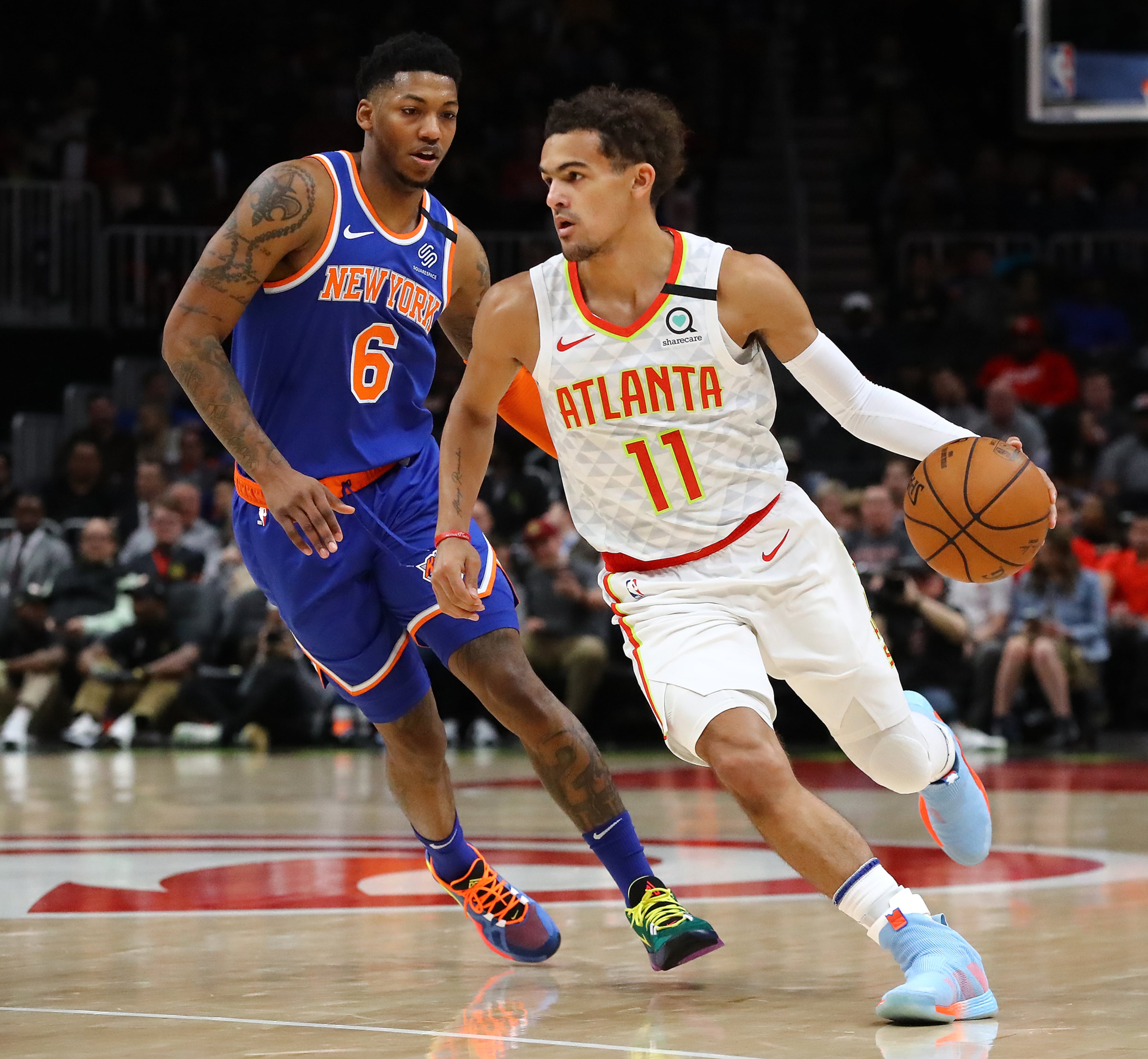 Hawks guard Trae Young drives against New York Knicks guard Elfrid Payton in a NBA basketball game on Wednesday, March 11, 2020, in Atlanta. As the country grapples with coronavirus and how to best combat the spread of the disease, athletic teams and organizations are asking themselves that same question. Curtis Compton ccompton@ajc.com