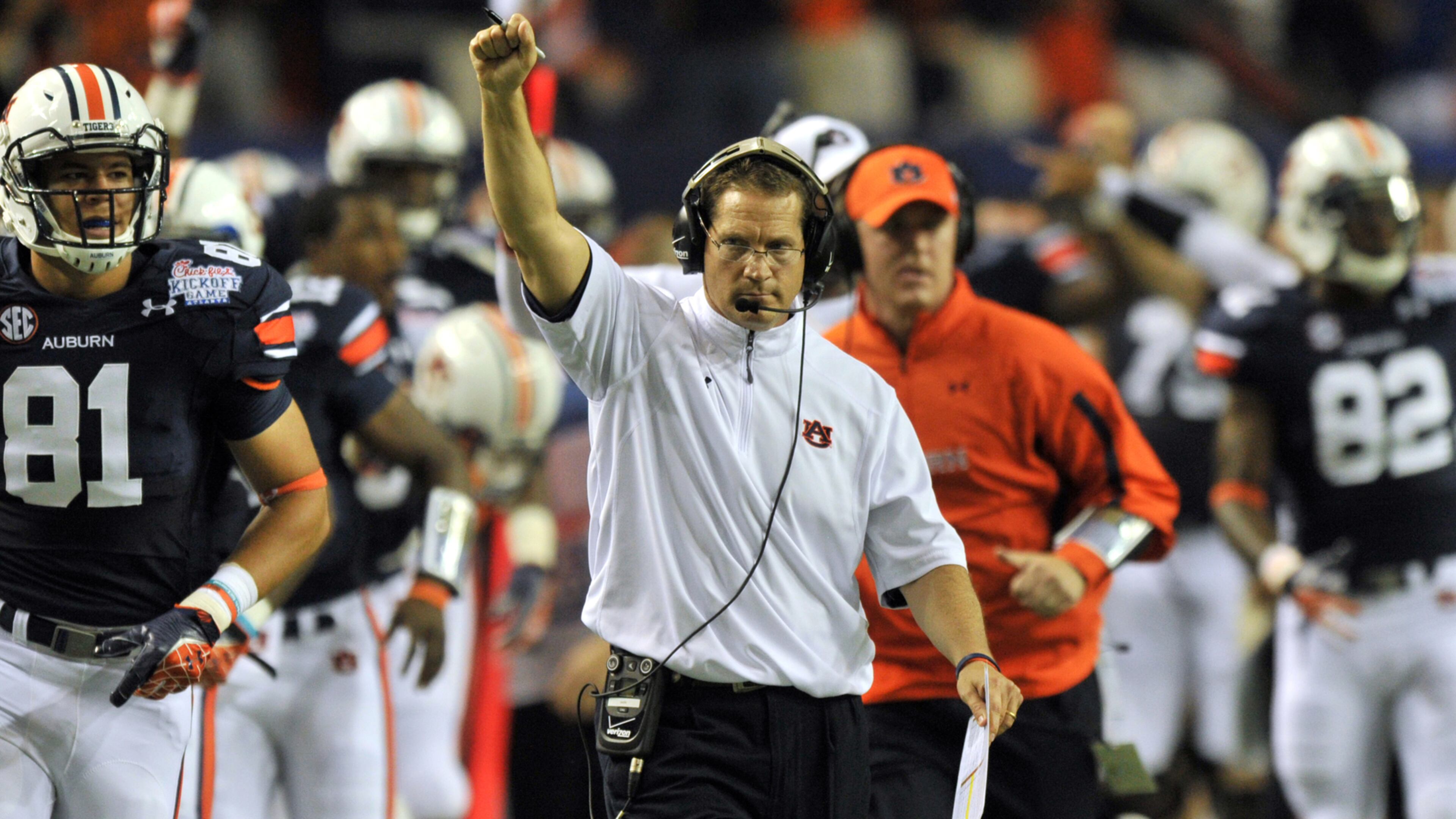 Gene Chizik (center) excelled as a defensive coordinator but quickly fizzed after winning a national title at Auburn with Cam Newton.