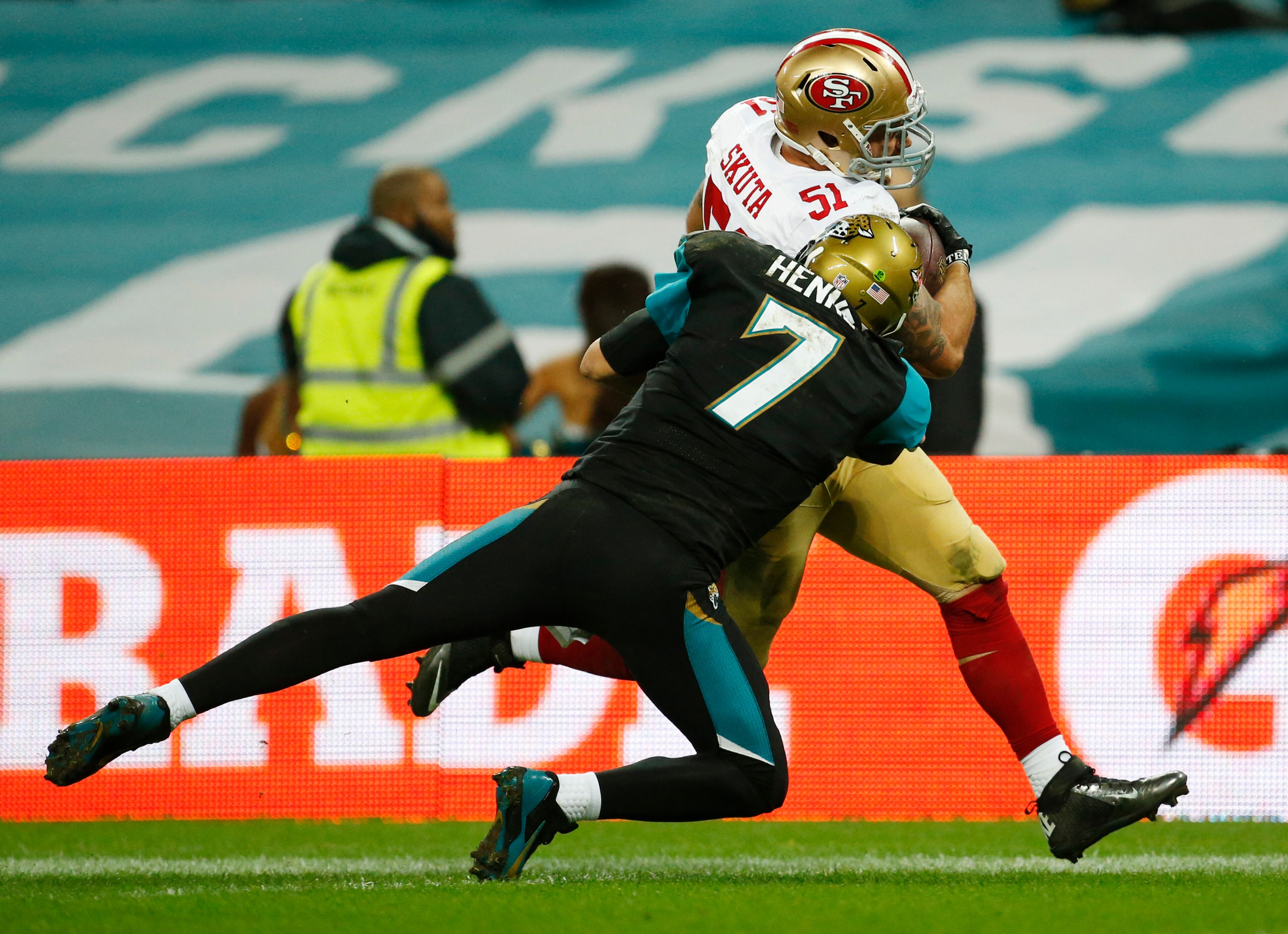 Jacksonville Jaguars quarterback Chad Henne (7) tries to tackle San Francisco 49ers outside linebacker Dan Skuta (51) as he scores on a 47-yard touchdown run after recovering a fumble by Jacksonville Jaguars tight end Marcedes Lewis during the second half of an NFL football game at Wembley Stadium, London. The San Francisco 49ers beat the Jacksonville Jaguars 42-10. (AP Photo/Matt Dunham)