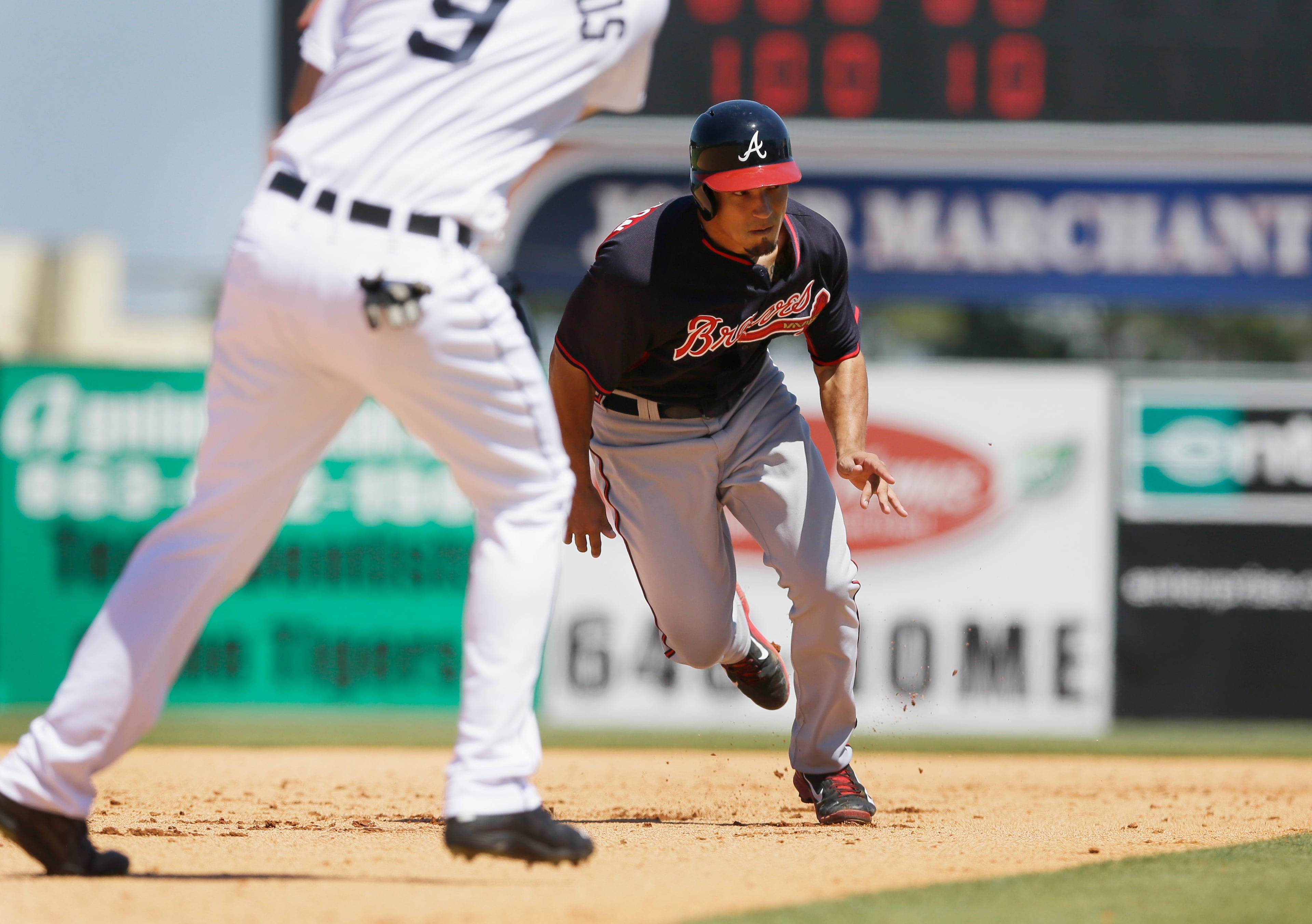 Atlanta Braves' Jace Peterson runs to third as Detroit Tigers third baseman Nick Castellanos waits on the throw during the sixth inning of a spring training exhibition baseball game in Lakeland, Fla., Monday, March 30, 2015. (AP Photo/Carlos Osorio)