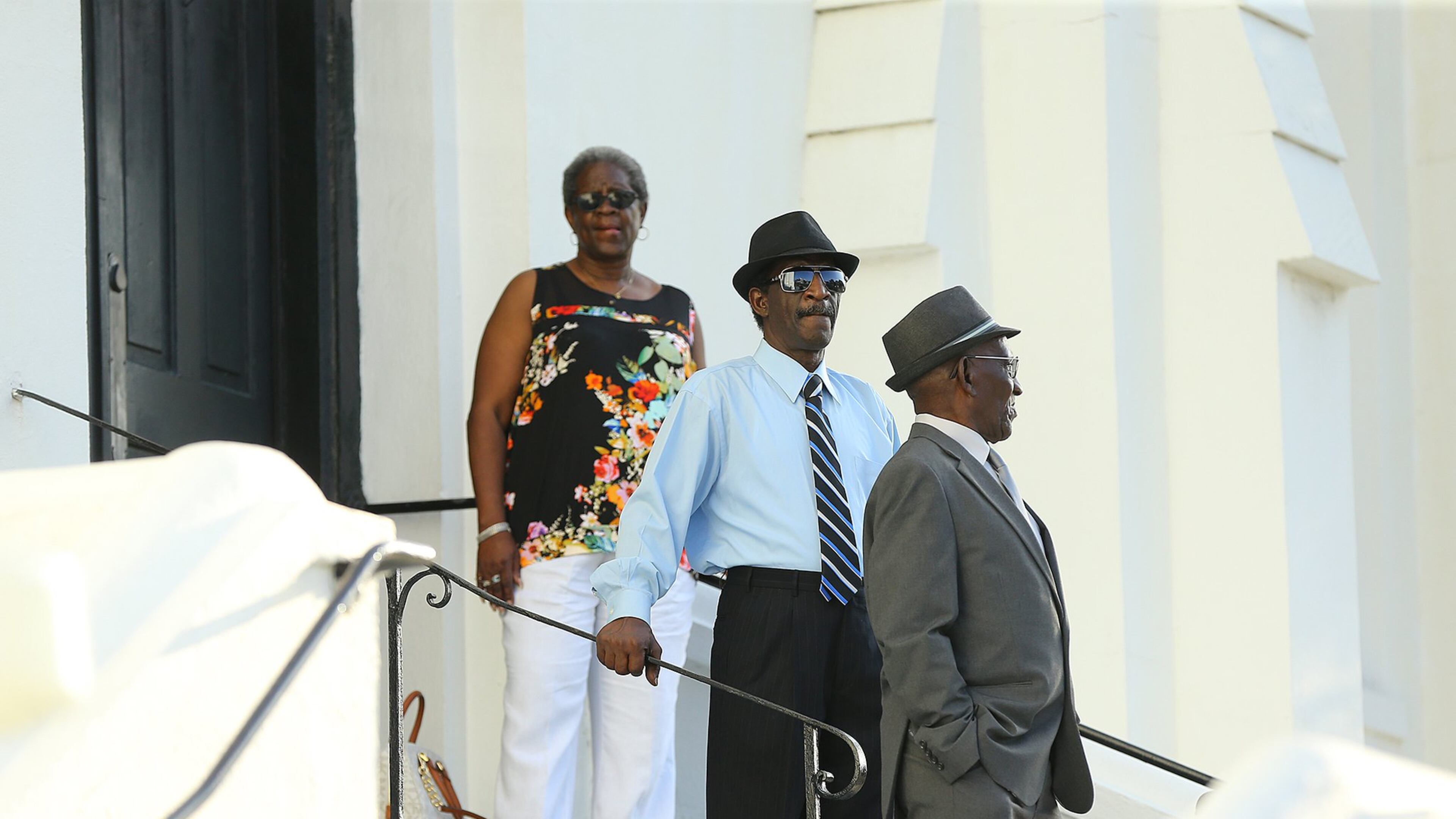 Church members stand on the steps and take in the crowd waiting to get in for Sunday service at the Mother Emanuel AME Church on June 21, 2015, in Charleston, S.C., several days after a gunman killed nine black people there. CURTIS COMPTON/ CCOMPTON@AJC.COM