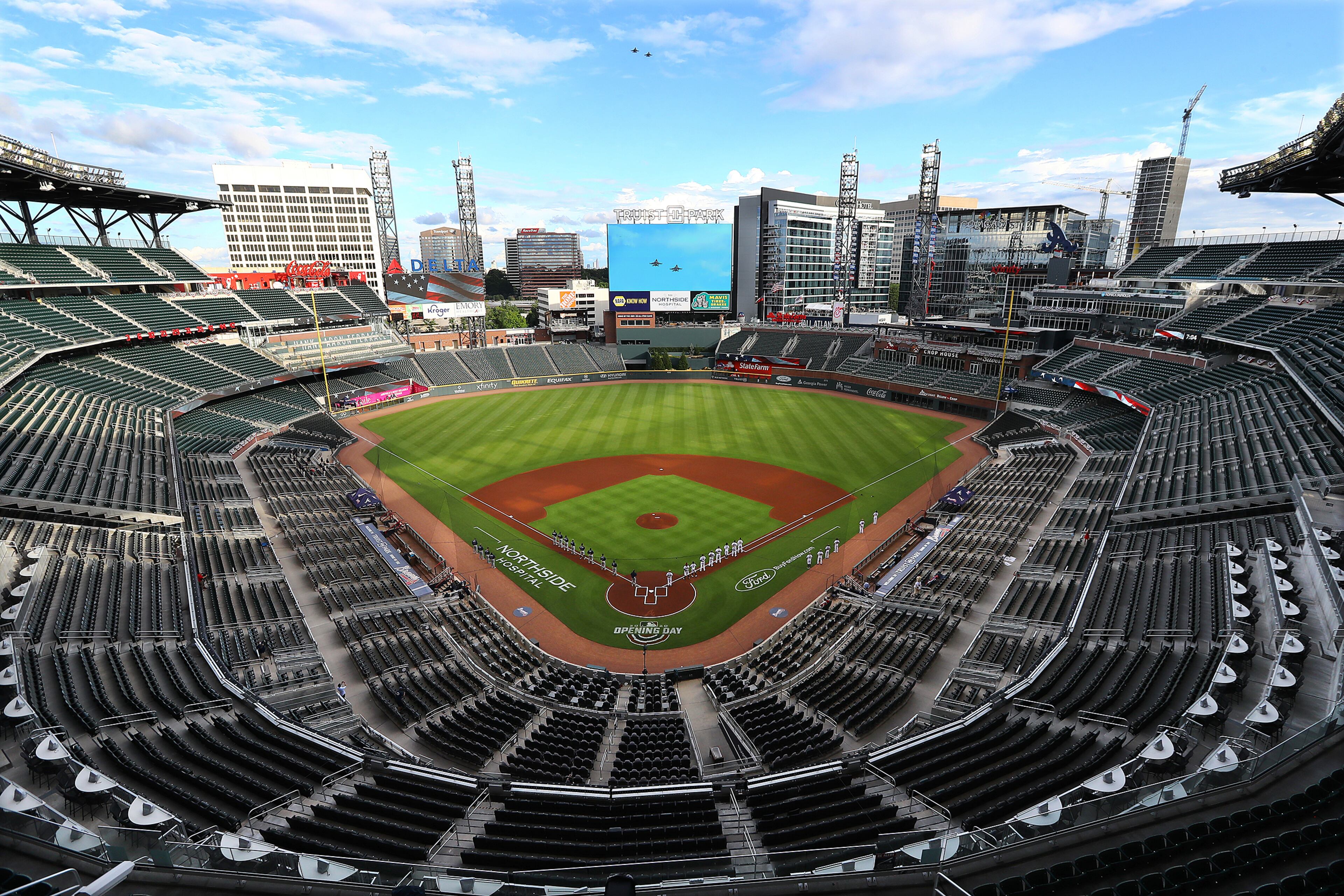 Truist Park is void of fans during the National Anthem and a flyover by a pair of jets before Wednesday's home opener for the Braves. (Curtis Compton/ccompton@ajc.com)