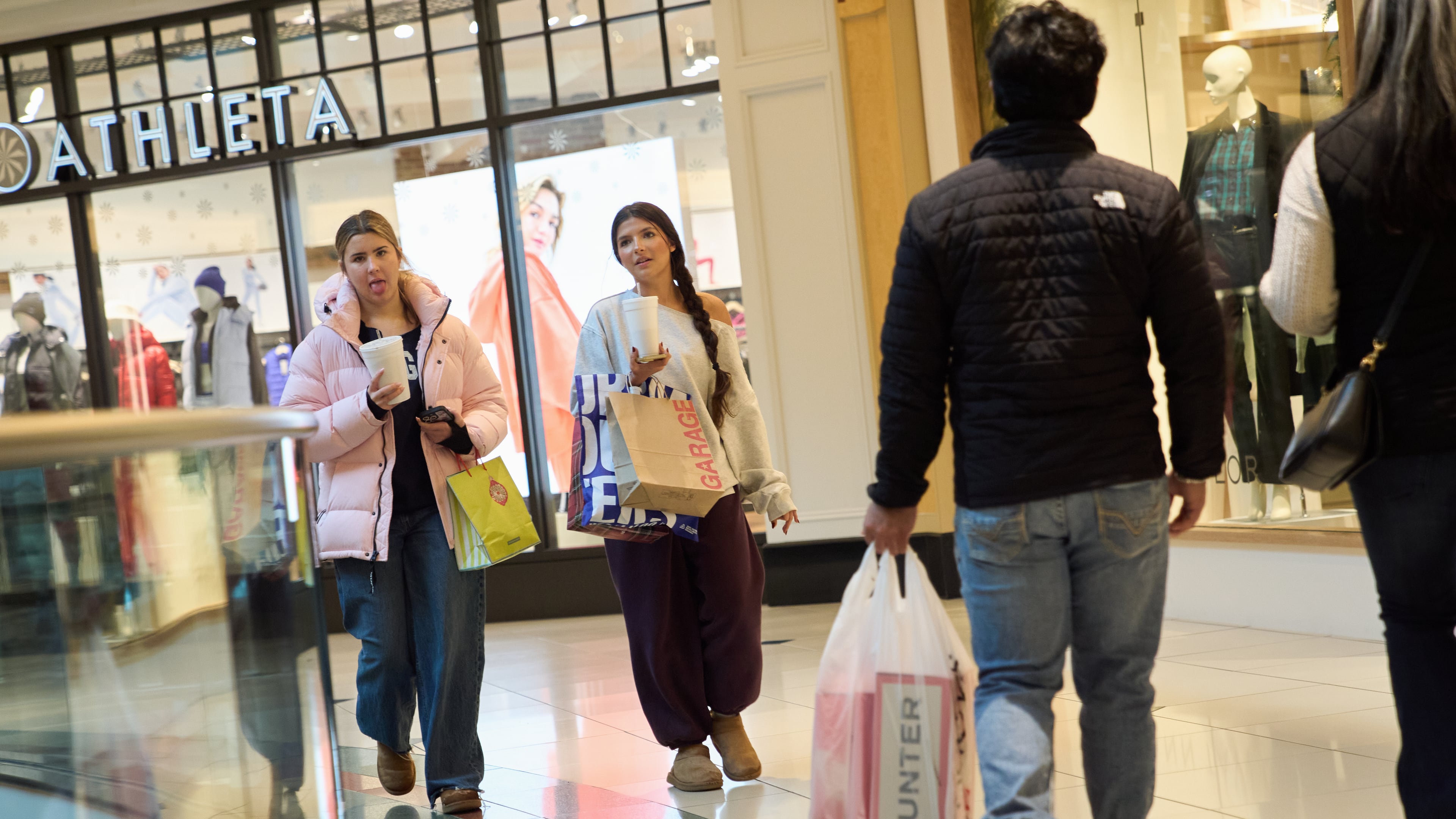Shoppers walk around the Somerset Collection mall, Wednesday, Dec. 10, 2025, in Troy, Mich. (AP Photo/Ryan Sun)
