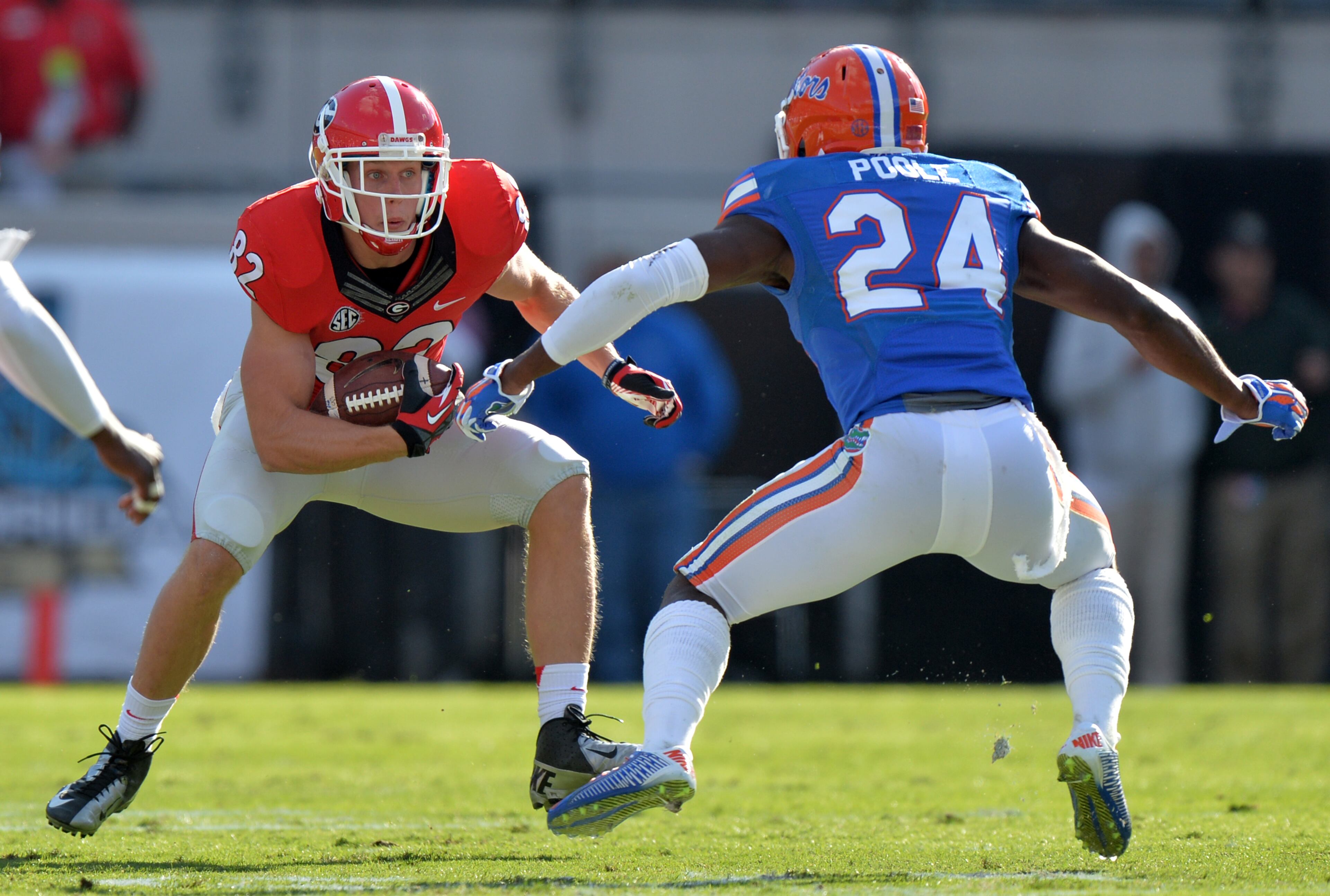 Georgia Bulldogs wide receiver Michael Bennett, trying to elude Florida Gators defensive back Brian Poole, had 6 catches for 60 yards in the Bulldog's 38-20 loss. BRANT SANDERLIN / BSANDERLIN@AJC.COM