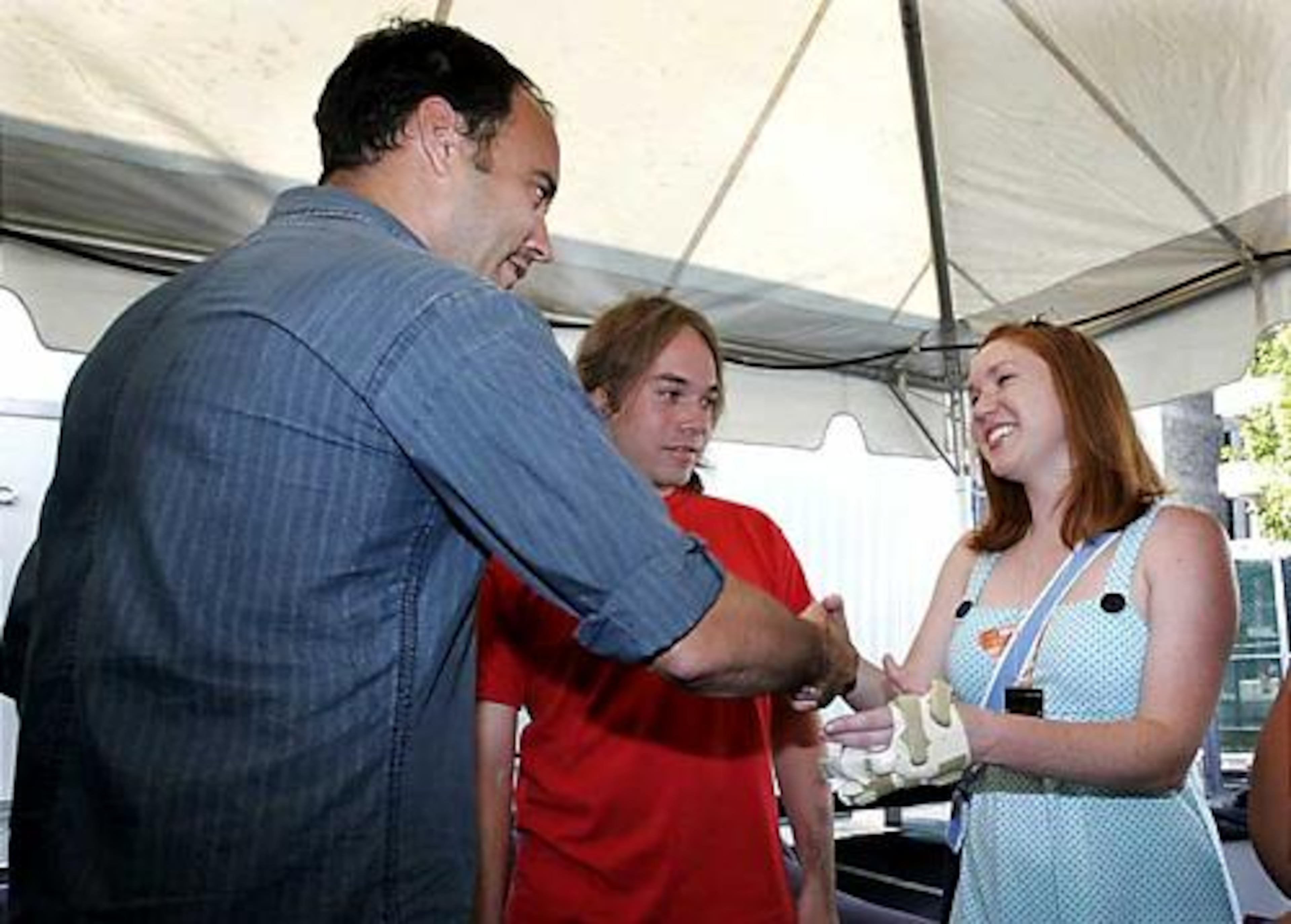 Dave Matthews greets injured Virginia Tech shooting victim Katelyn Carney, and her guest Paul Gieger, center, prior to the benefit concert.