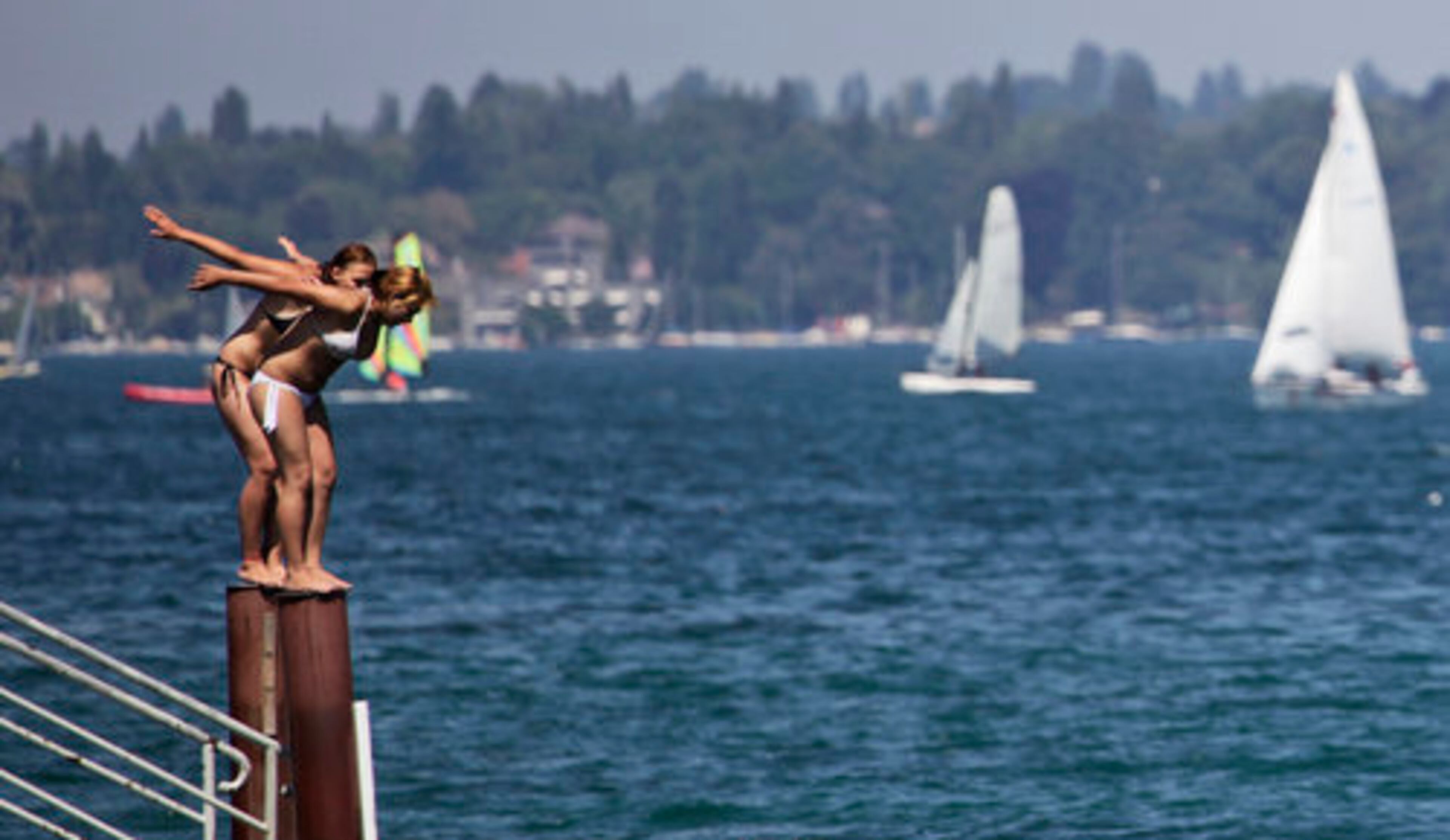 Two women attempt to jump into Lake Geneva in the center of Geneva, Switzerland.