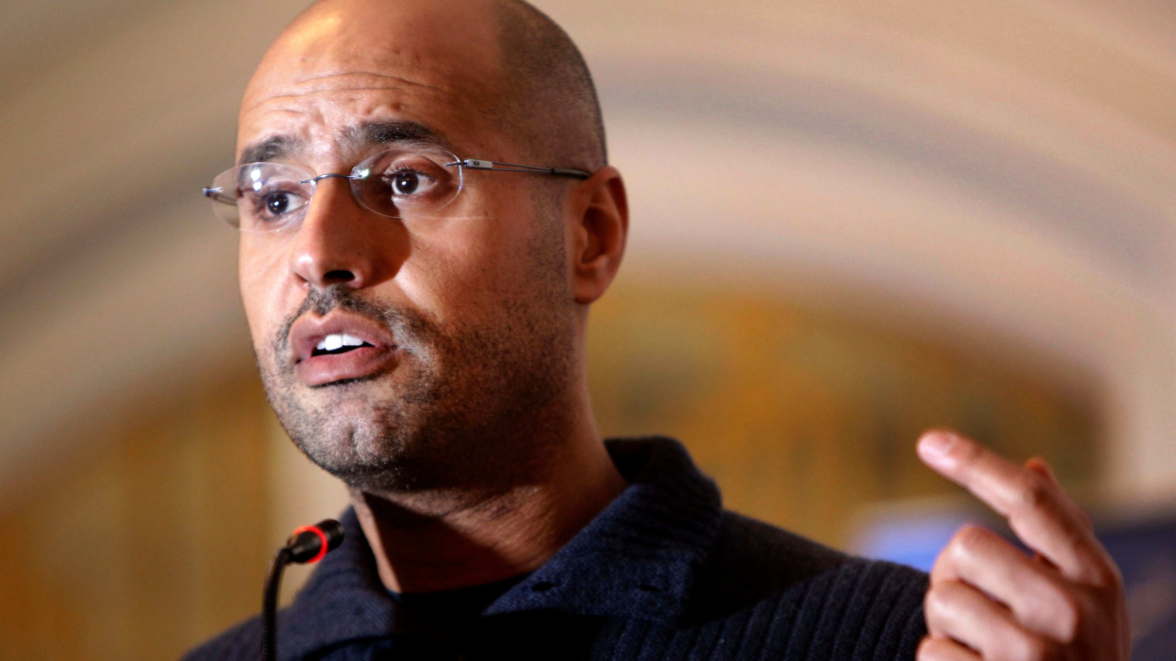 FILE - In this Feb. 25, 2011, file photo, Seif al-Islam Gadhafi speaks to the media at a press conference in a hotel in Tripoli, Libya. (AP Photo/Ben Curtis, File)