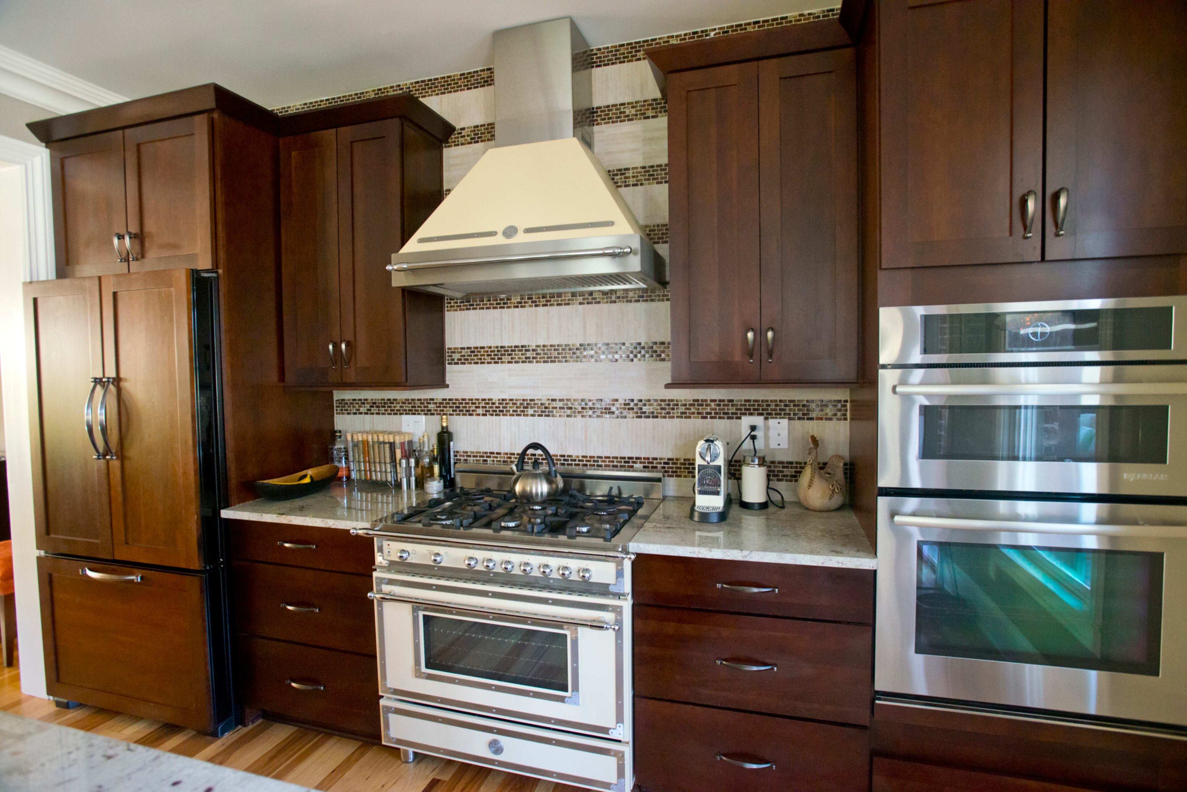 A vintage-looking Brutozoni stove in cream makes a statement in the kitchen. “It’s my crowning glory in my kitchen,” Cathy said. The kitchen countertops are a black recycled granite composite, and the boomerang-shaped bar top is custom-made out of zebrawood.