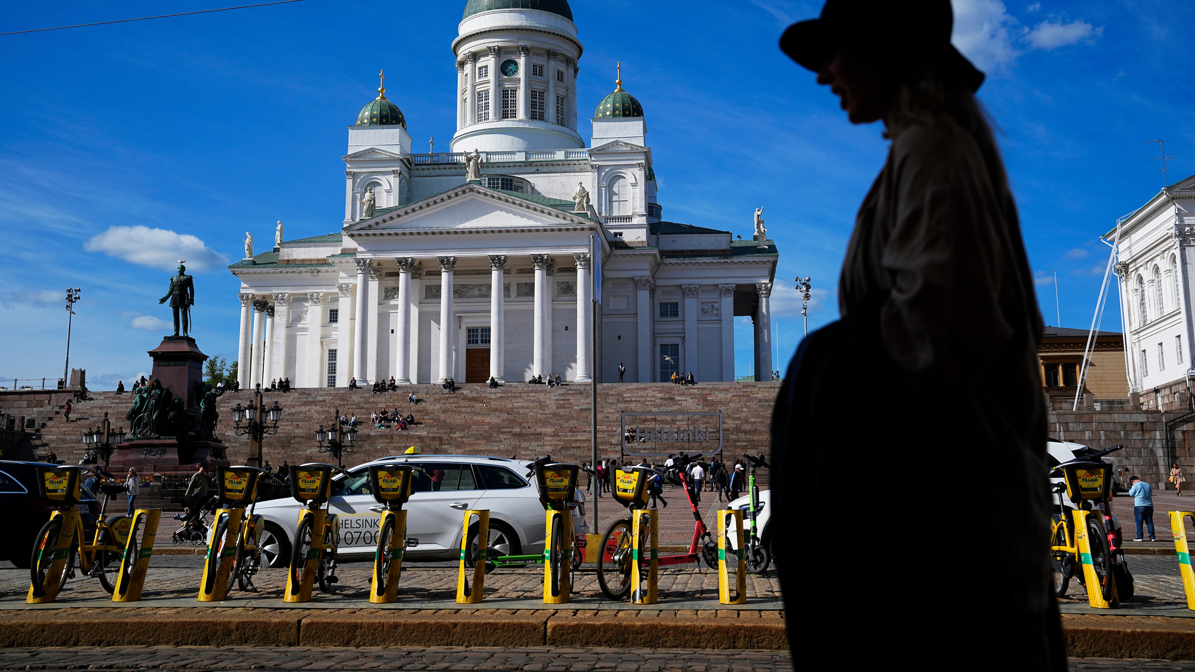 FILE - A woman walks past the Helsinki Cathedral in Helsinki, May 29, 2023. (AP Photo/Pavel Golovkin, File)