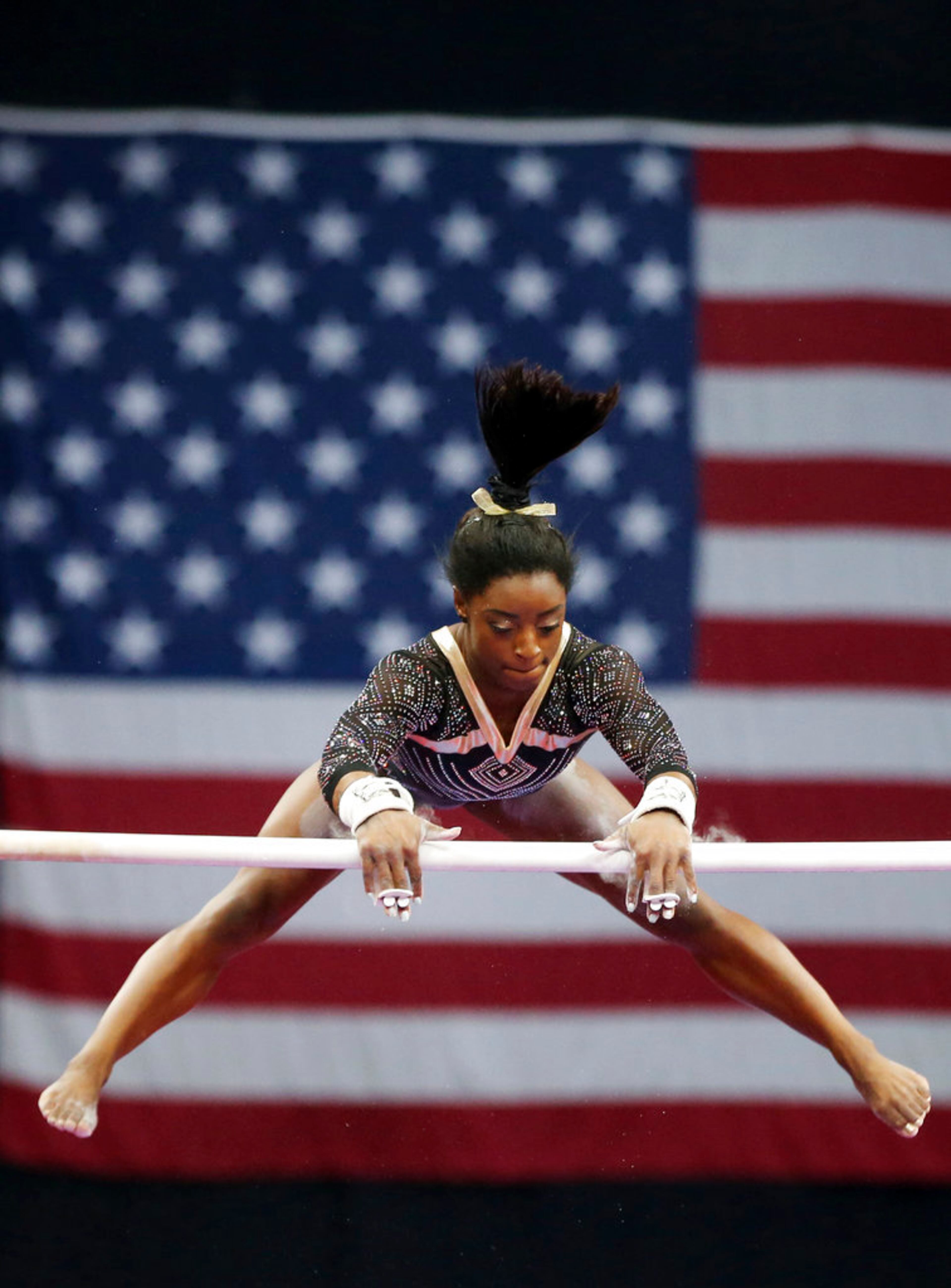 Simone Biles competes on the uneven bars at the U.S. Gymnastics Championships, Friday, Aug. 17, 2018, in Boston. (AP Photo/Elise Amendola)