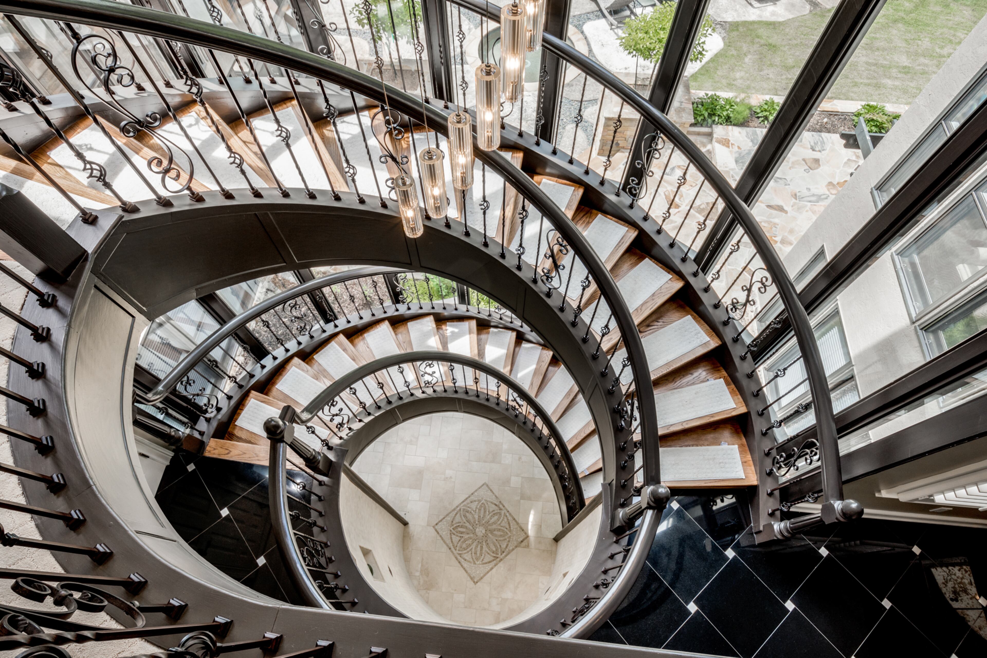 Dramatic spiral staircase to all 3 floors. Text by Melanie White.