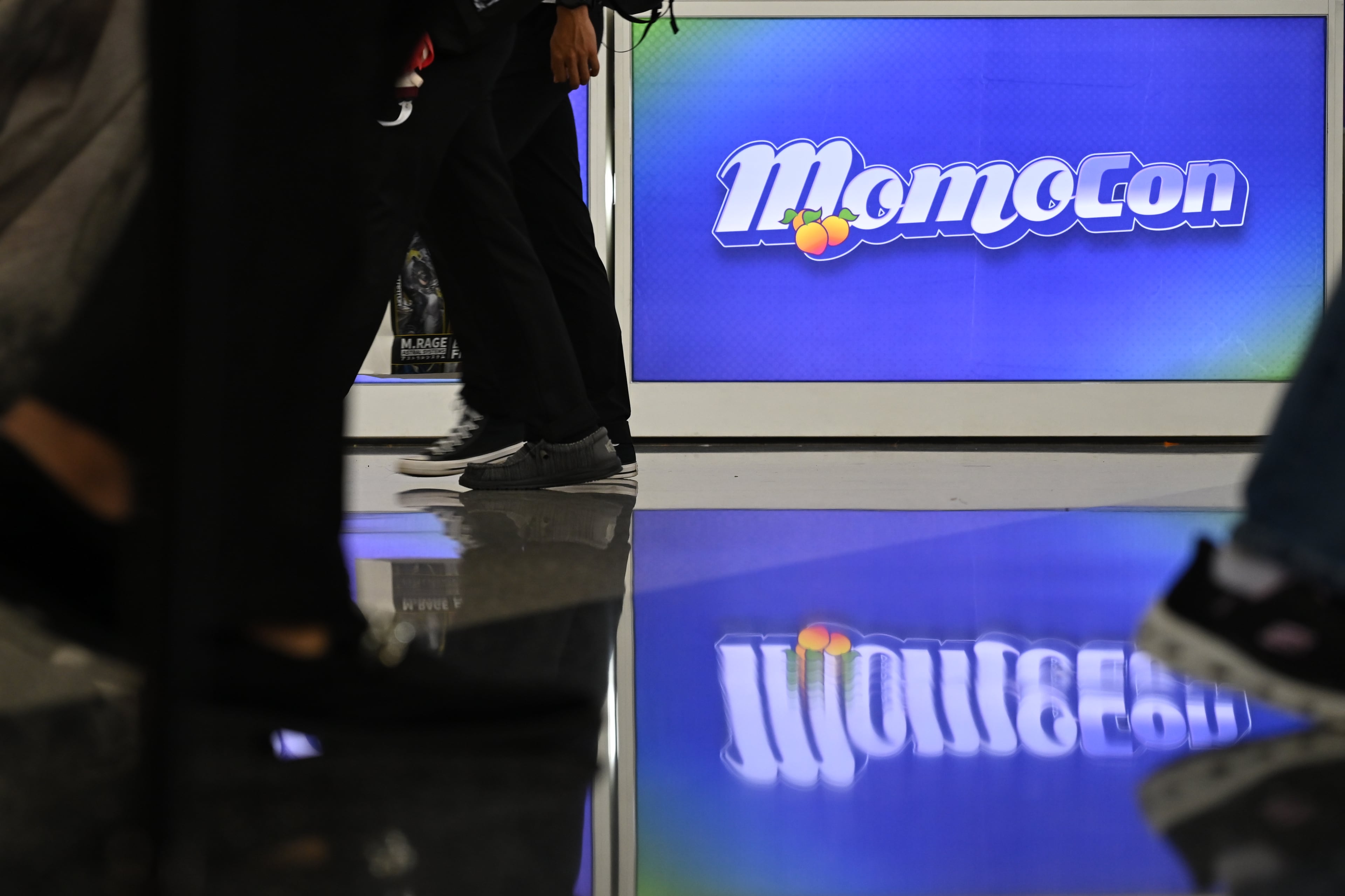 A MomoCon sign is reflected off the ground at the Georgia World Congress Center in Atlanta on Friday, May 22, 2026. (Tyler Sun for the AJC)