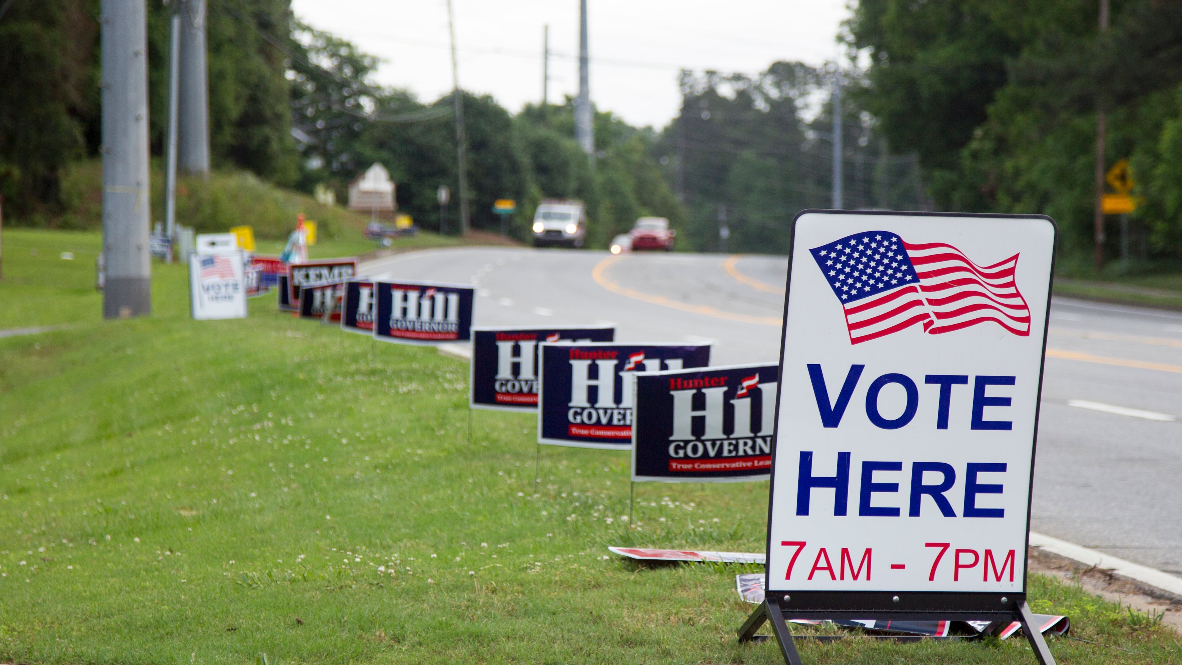 Hill and Kemp campaign signs line Canton Road leading up to the polling location at Noonday Baptist Church in Marietta, Georgia, on Tuesday, May 22, 2018. (REANN HUBER/REANN.HUBER@AJC.COM)