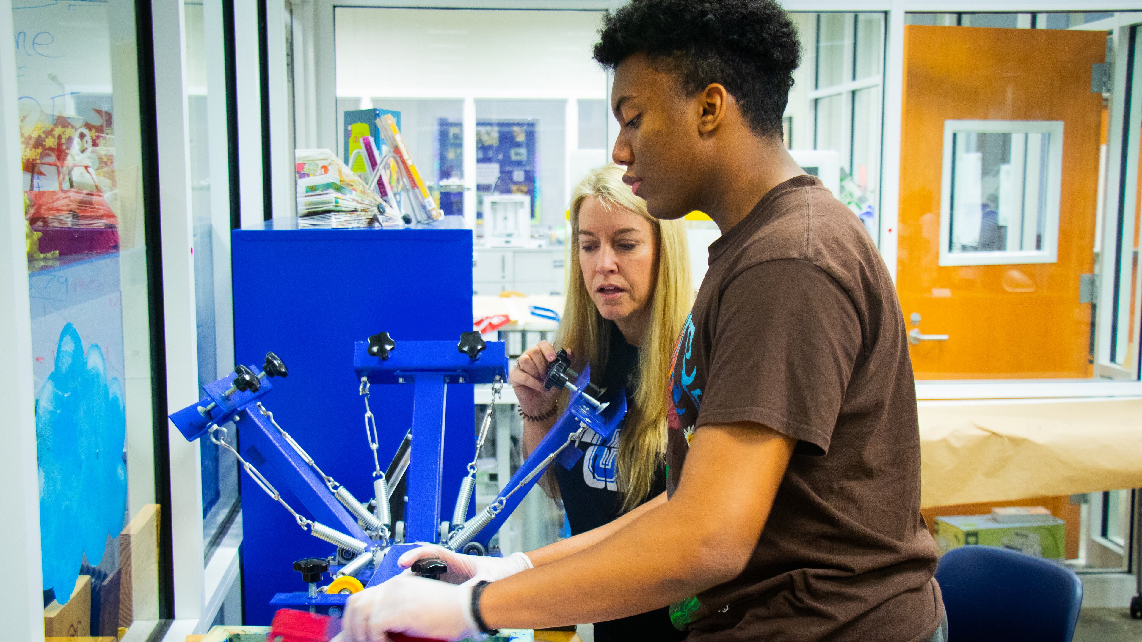 Christa Heath works with student Aaron Veschi in Centennial High's maker's space.