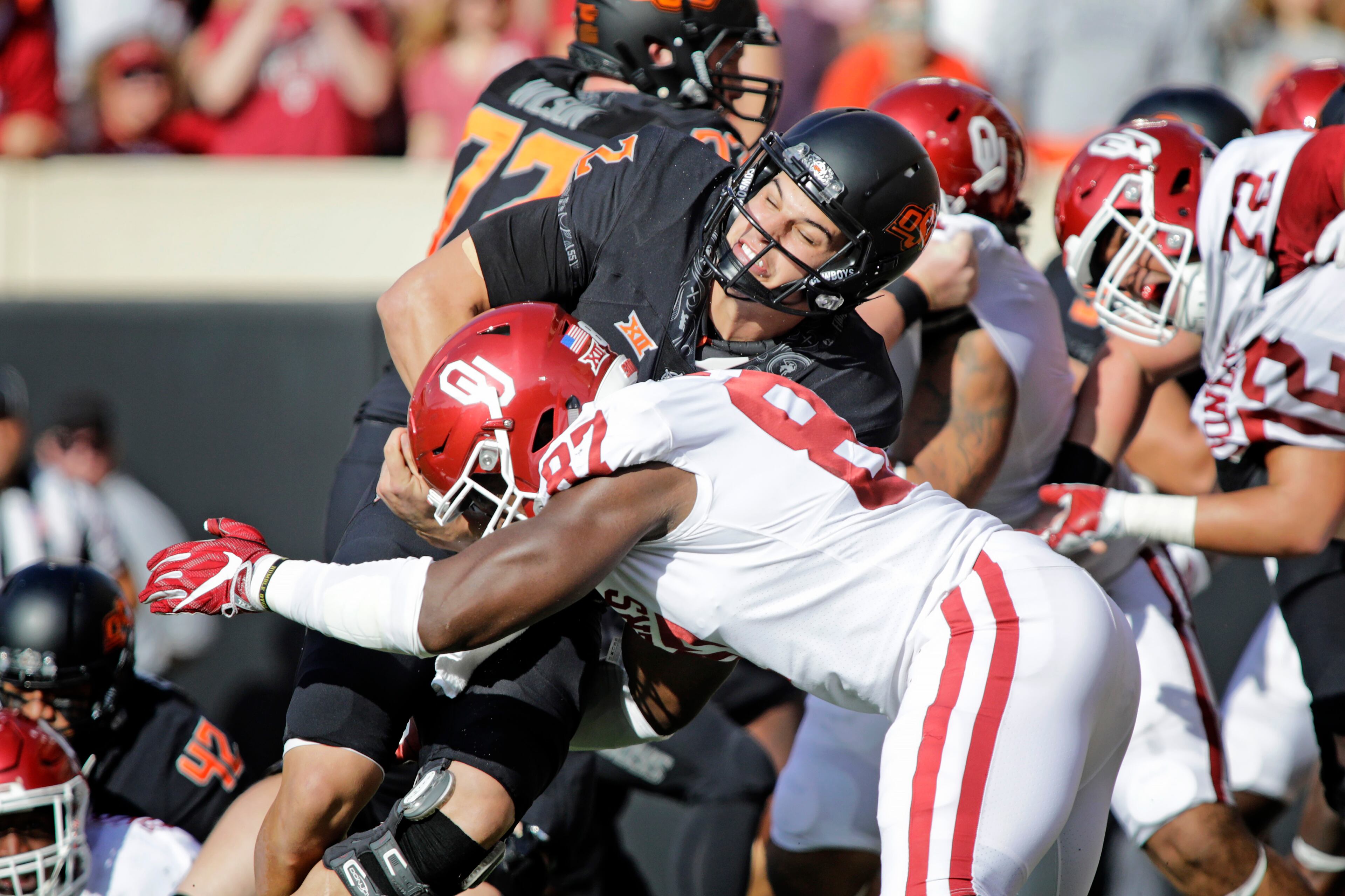 STILLWATER, OK - NOVEMBER 04: Quarterback Mason Rudolph #2 of the Oklahoma State Cowboys is hit by defensive end D.J. Ward #87 of the Oklahoma Sooners at Boone Pickens Stadium on November 4, 2017 in Stillwater, Oklahoma. Oklahoma defeated Oklahoma State 62-52. (Photo by Brett Deering/Getty Images)