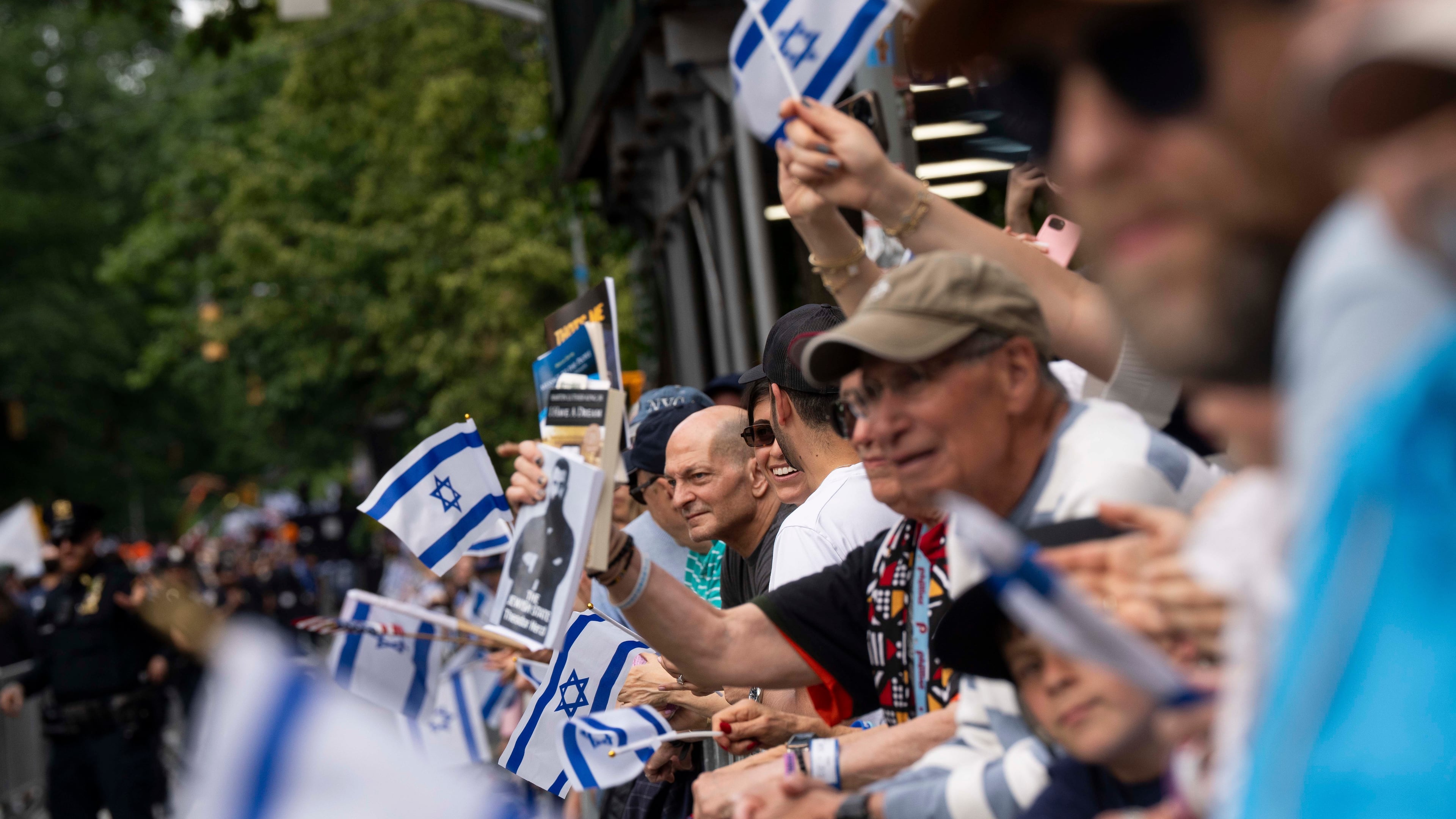 Spectators wave flags during the Israel Day Parade, Sunday, May 31, 2026, in New York. (AP Photo/Emil T. Lippe)