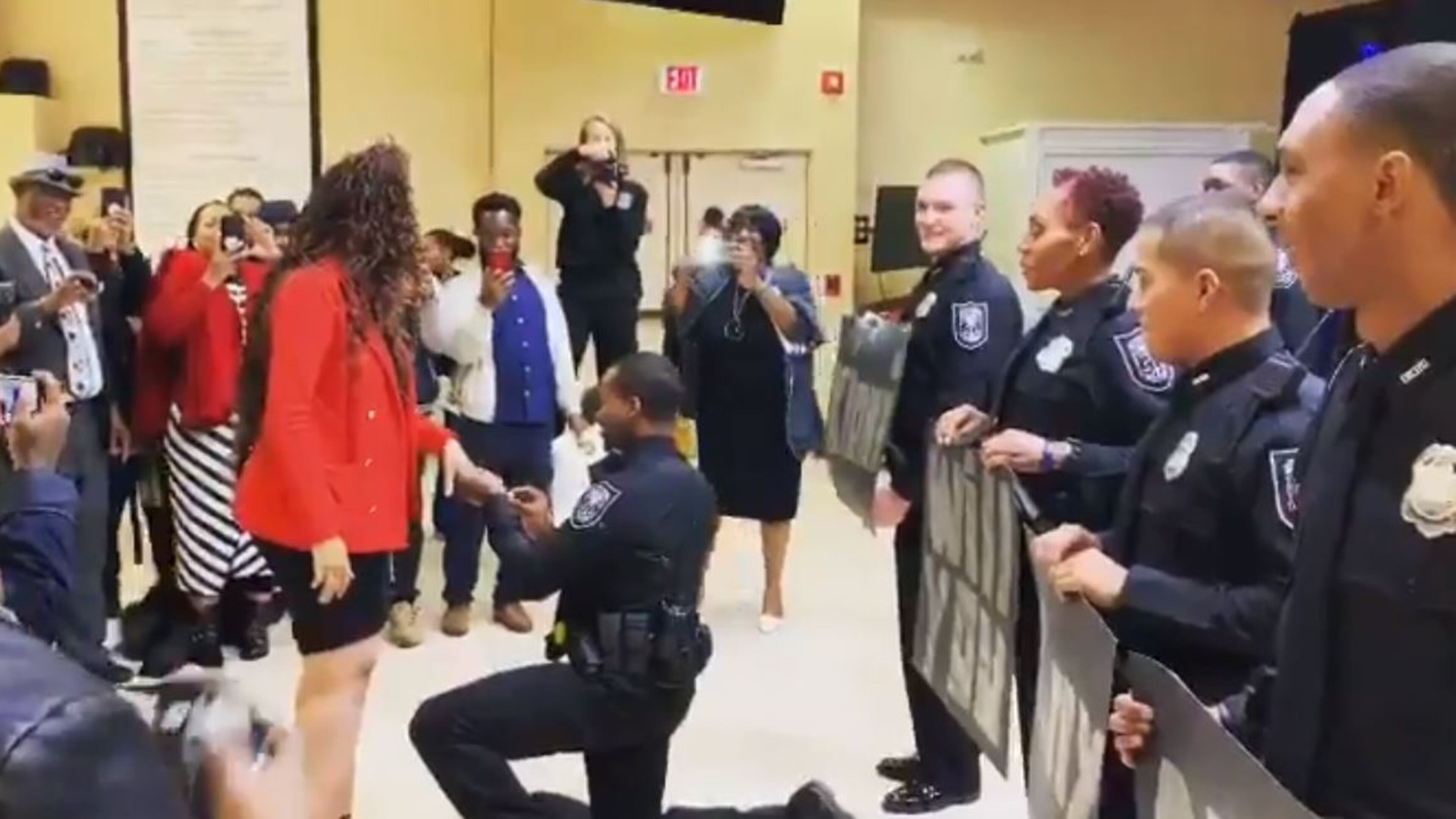 Officer Walker got down on one knee during Friday's graduation ceremony.