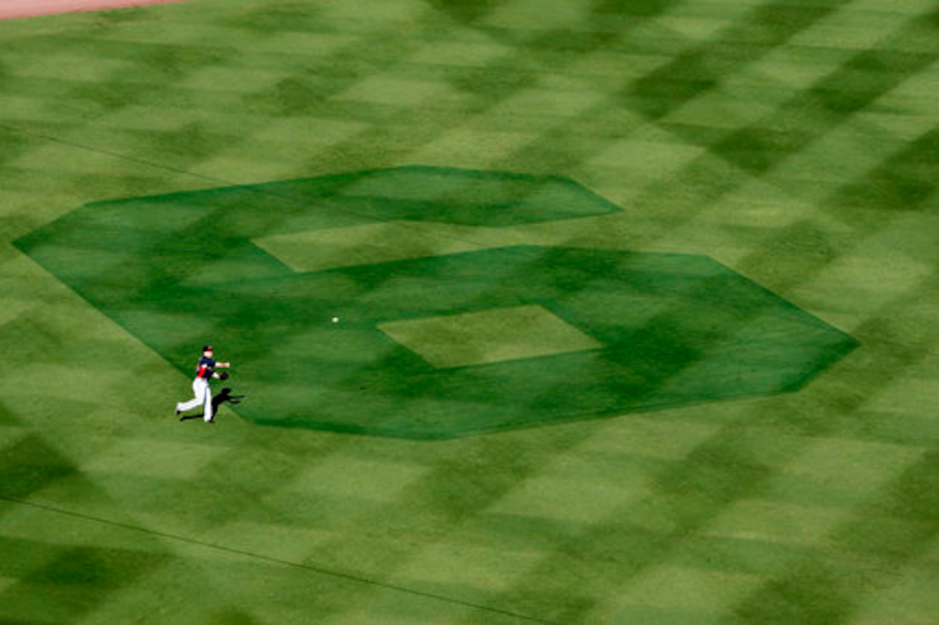 Nate McLouth warms up in the outfield next to a giant six created by the Turner Field ground crew in honor of Bobby Cox.