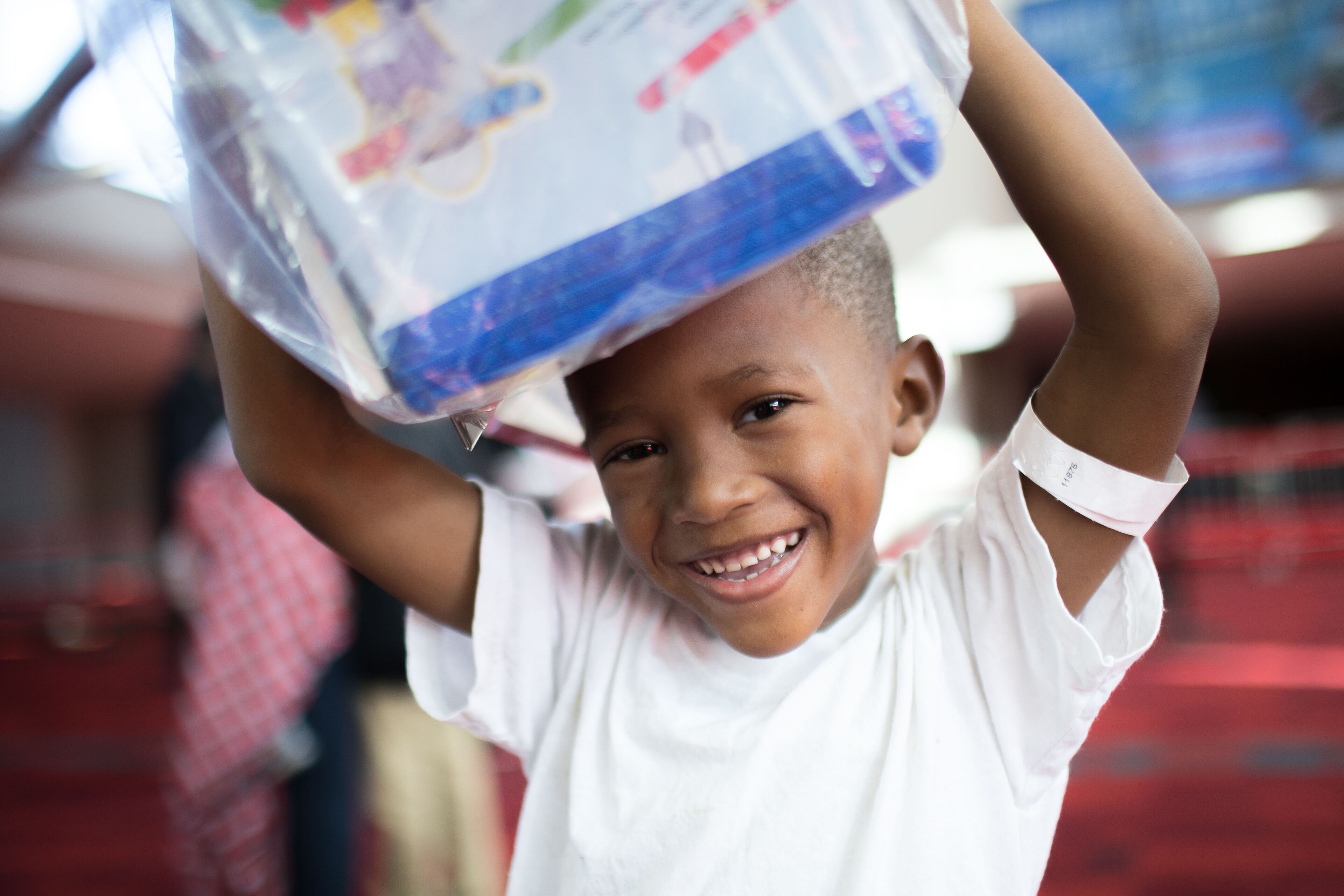 Lenard Allen, 5, holds a bag full of gifts he received at the annual Hosea Feed the Homeless Christmas at the Georgia World Congress Center on Christmas Day, Friday, Dec. 25, 2015, in Atlanta. BRANDEN CAMP/SPECIAL