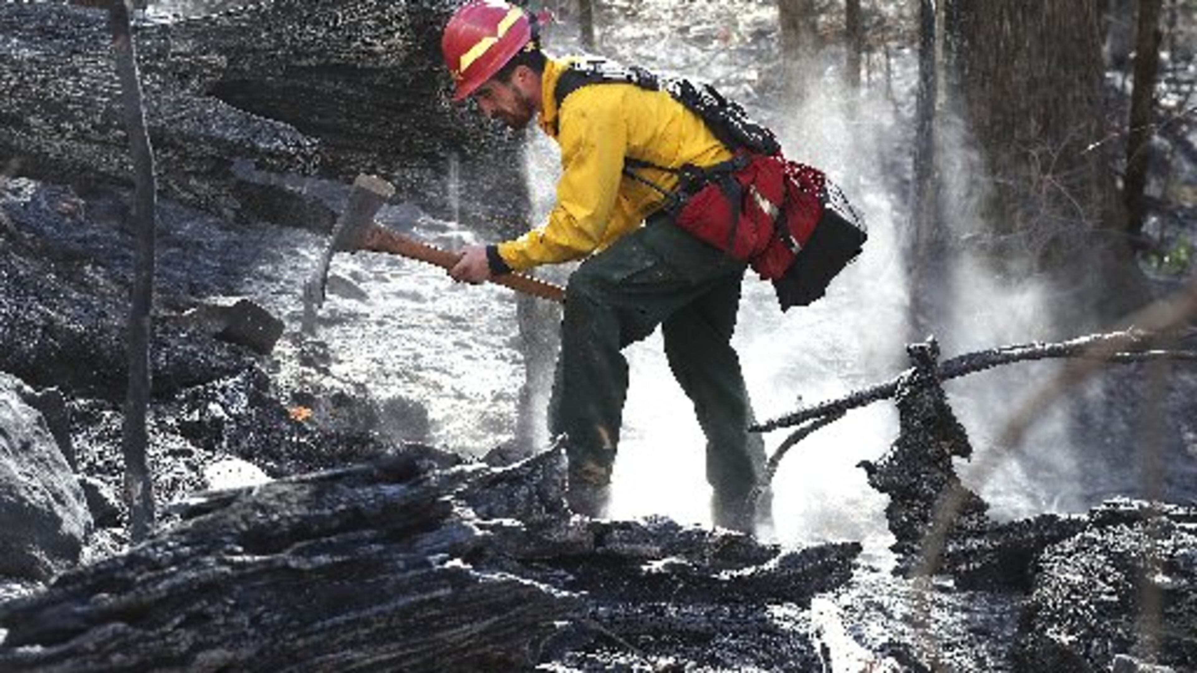 Cody Henderson works to fight the Rock Mountain fire in Rabun County. CURTIS COMPTON / CCOMPTON@AJC.COM