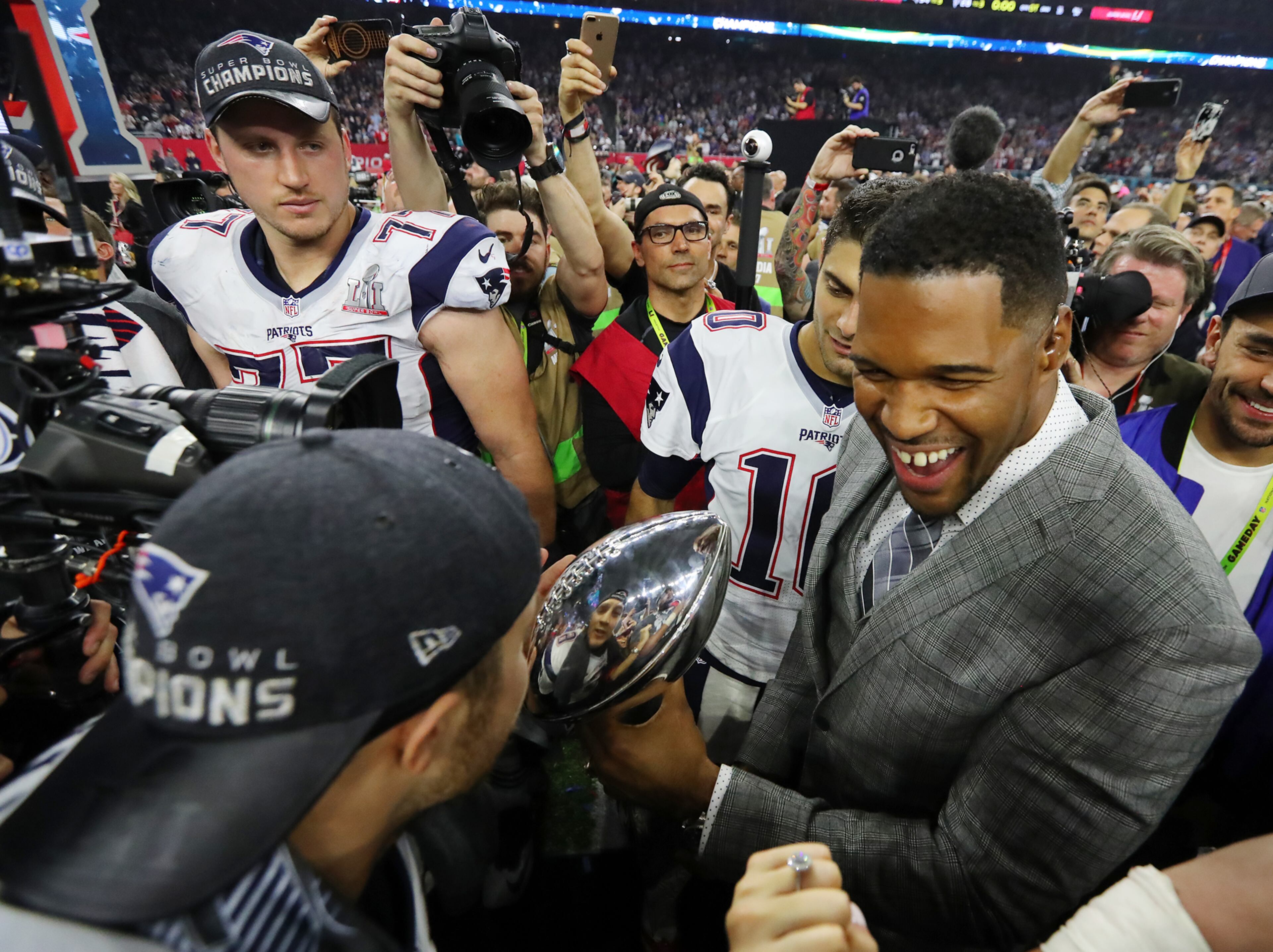 February 5, 2017, Houston: Michael Strahan carrys the Lombardi Trophy to the stage after the Patriots beat the Falcons 34-28 to win the Super Bowl on Sunday Feb. 5, 2017, in Houston. Curtis Compton/ccompton@ajc.com