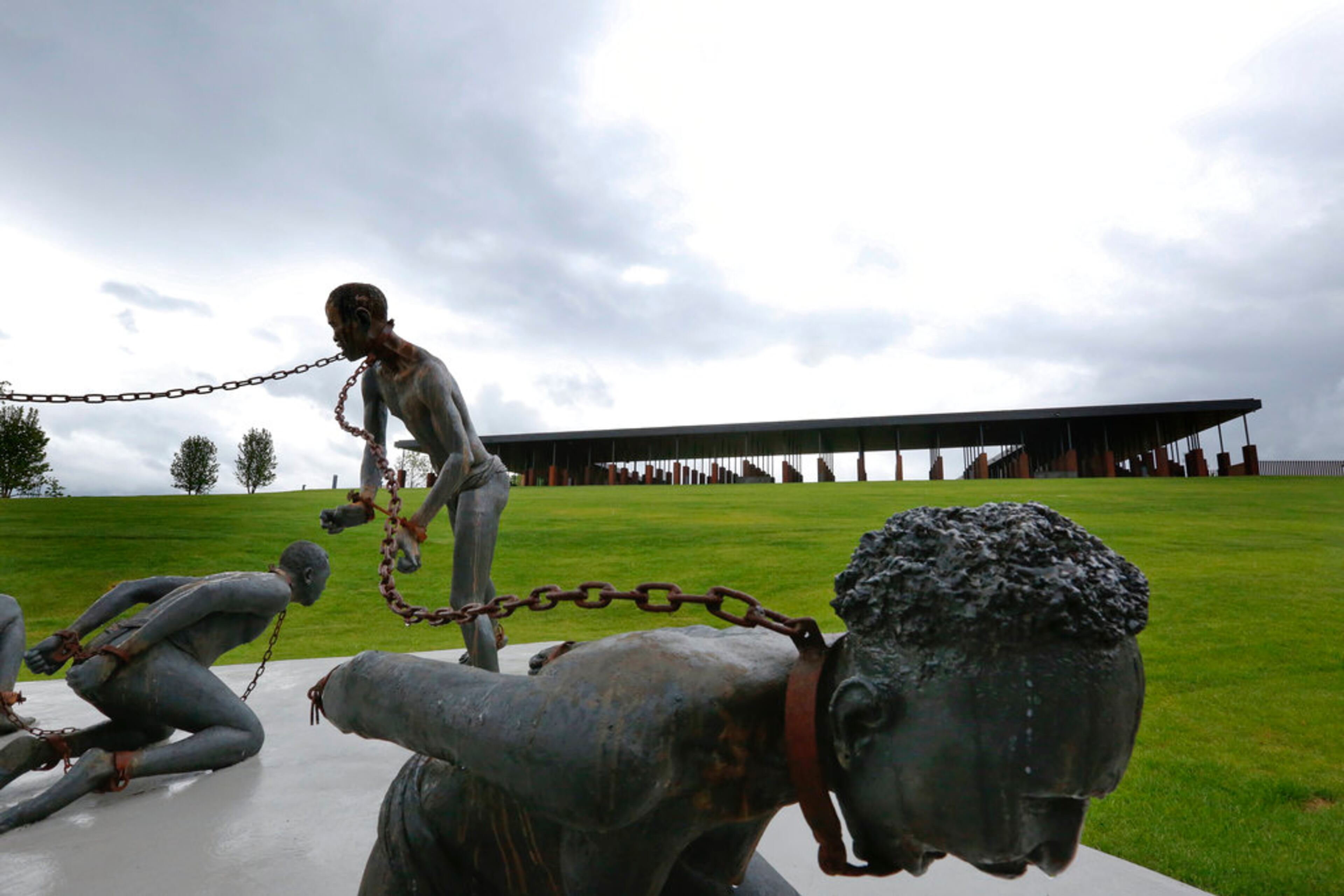 Part of a statue depicting chained people is on display at the National Memorial for Peace and Justice, a new memorial to honor thousands of people killed in racist lynchings, Sunday, April 22, 2018, in Montgomery, Ala. The national memorial aims to teach about America's past in hope of promoting understanding and healing. It's scheduled to open on Thursday. (AP Photo/Brynn Anderson)