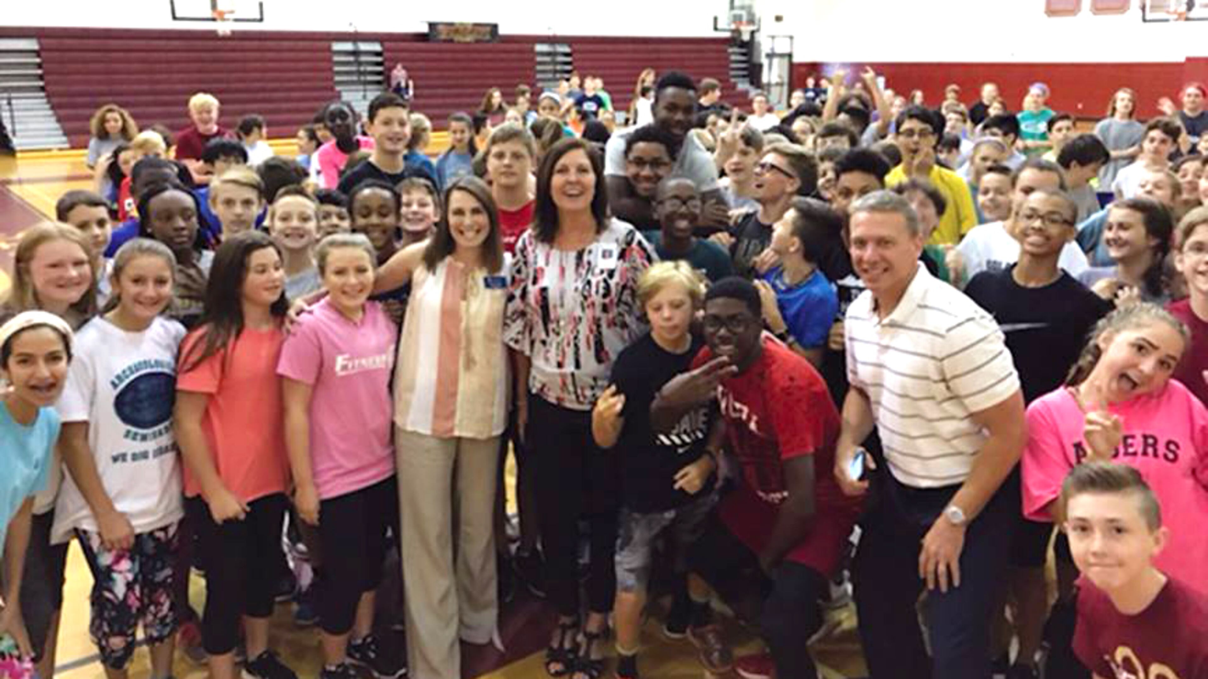 School Board Member Kelly Poole, center, stops by the gym to see physical education classes in action at Mill Creek Middle School during the first week of school, Aug. 4, 2017. CHEROKEE COUNTY SCHOOLS